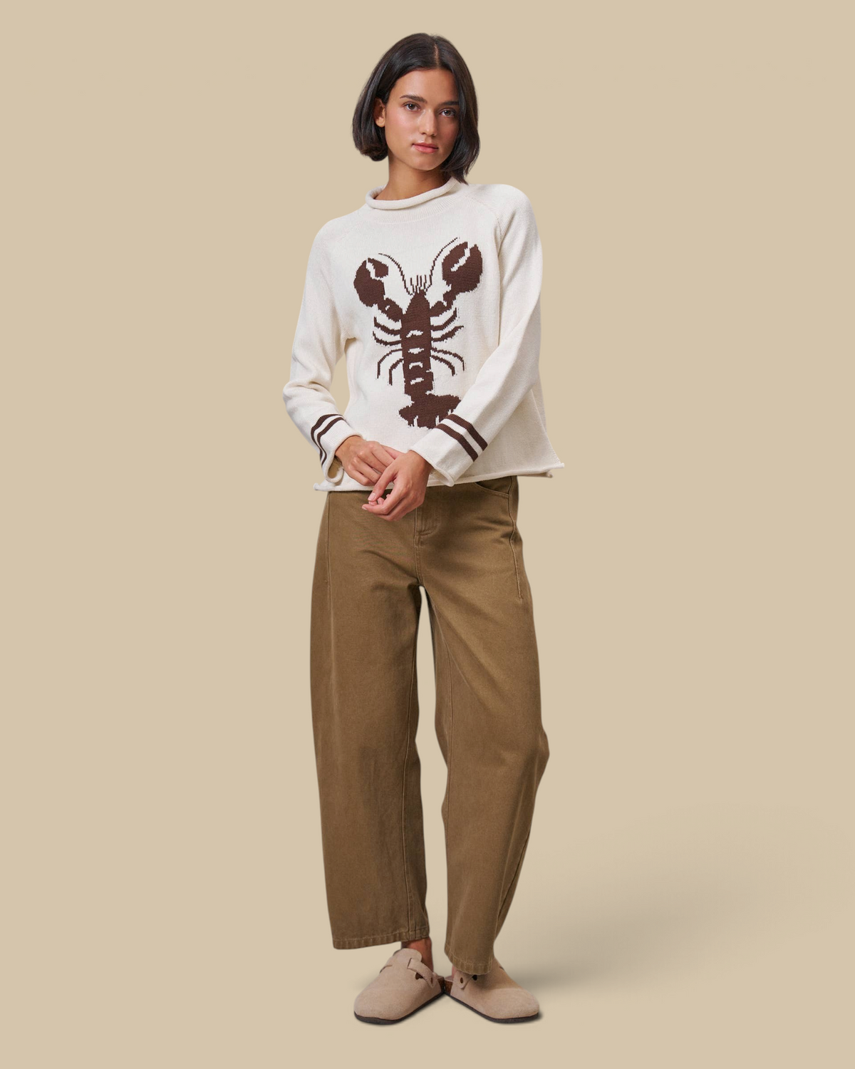 Model wearing Homestyle Collective tan cotton barrel leg pants with a high-rise waist and cropped ankle length.