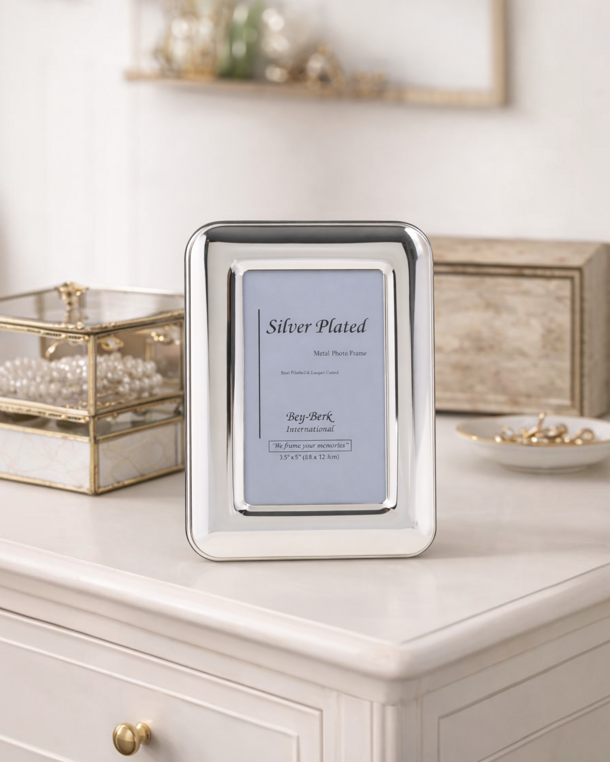Homestyle Collective silver-plated 4x6 picture frame with a polished finish and sturdy easel back on a white table.