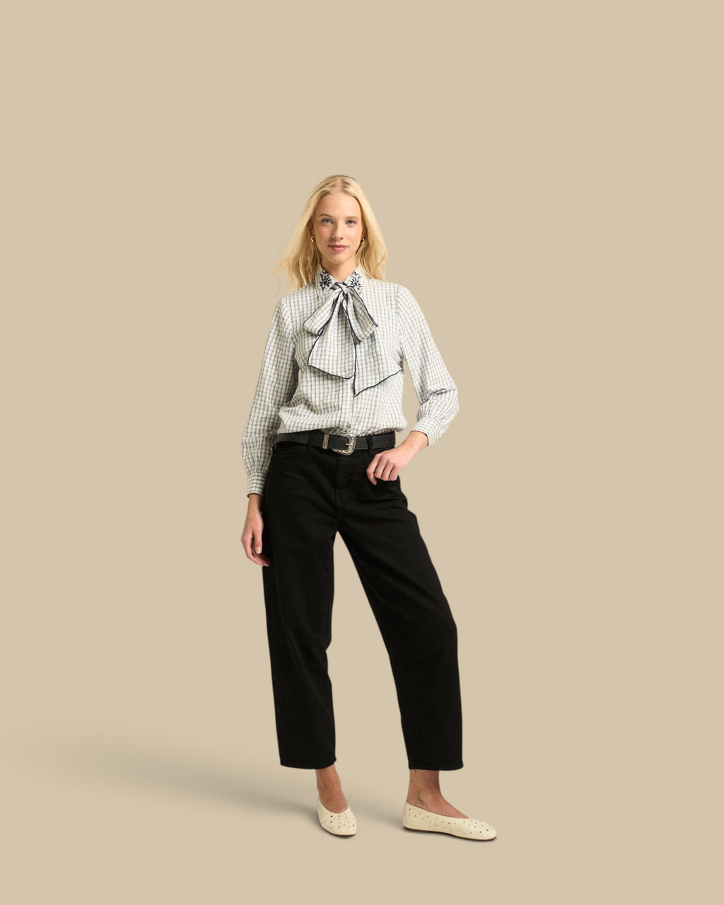 Homestyle Collective Lily Blouse in navy gingham cotton with embroidered neckline and tie detail on a blonde model.