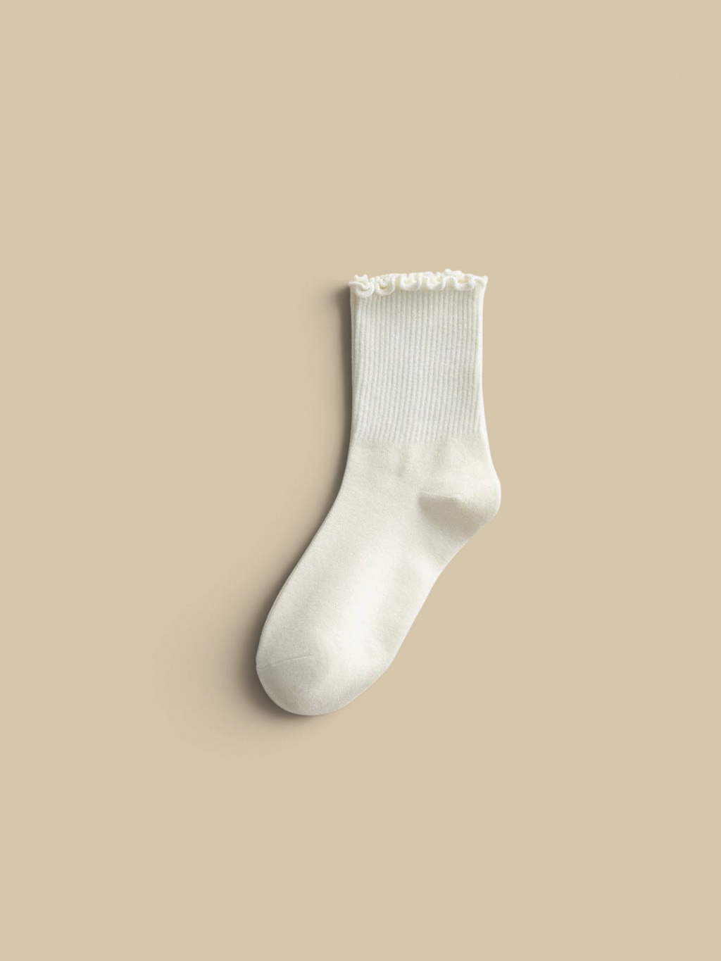 Homestyle Collective cream ribbed ankle socks with a delicate ruffled flounce trim on a neutral textured background.