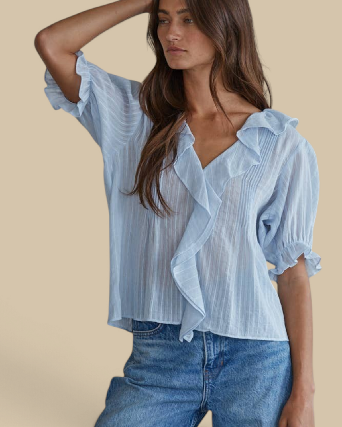 Homestyle Collective powder blue cotton blouse with ruffle trim, pintuck details, and V-neck worn by a model.