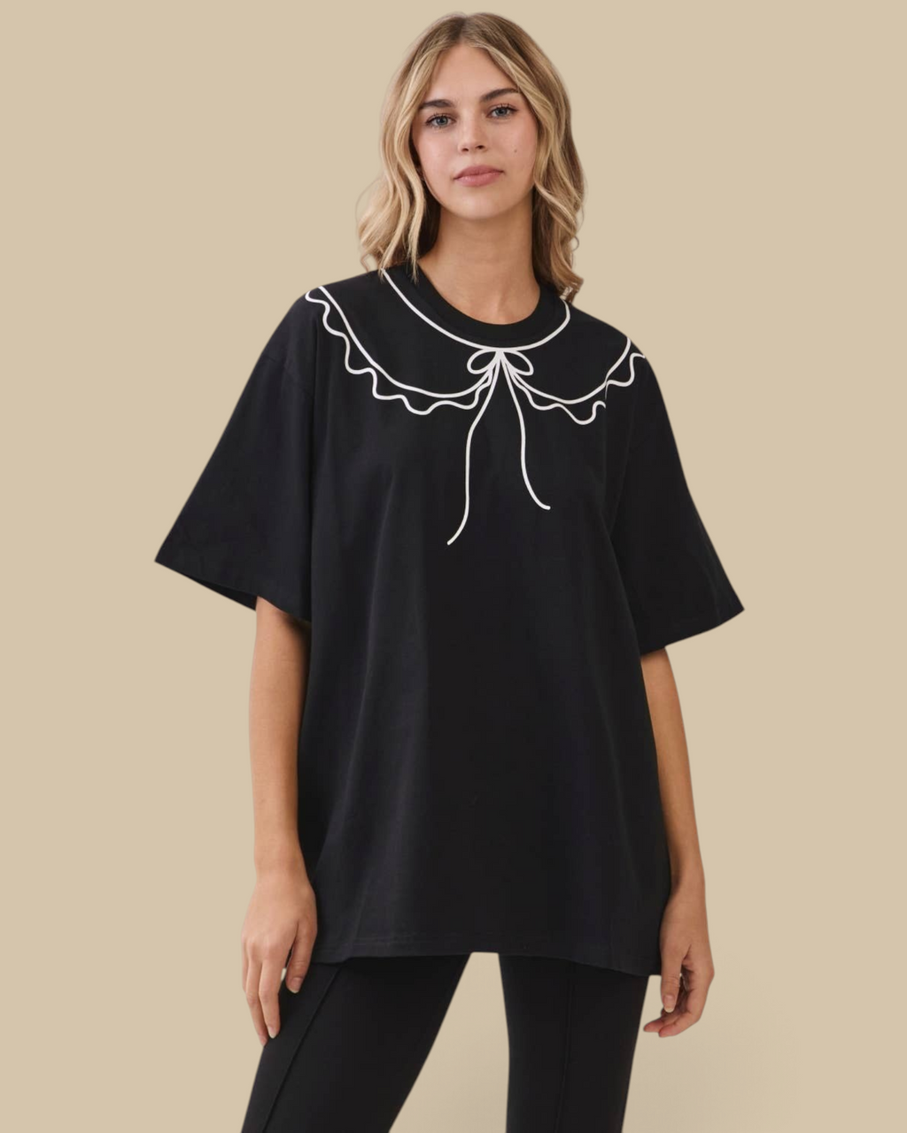 Homestyle Collective oversized black cotton tunic tee featuring a white scalloped statement collar with bow detail.