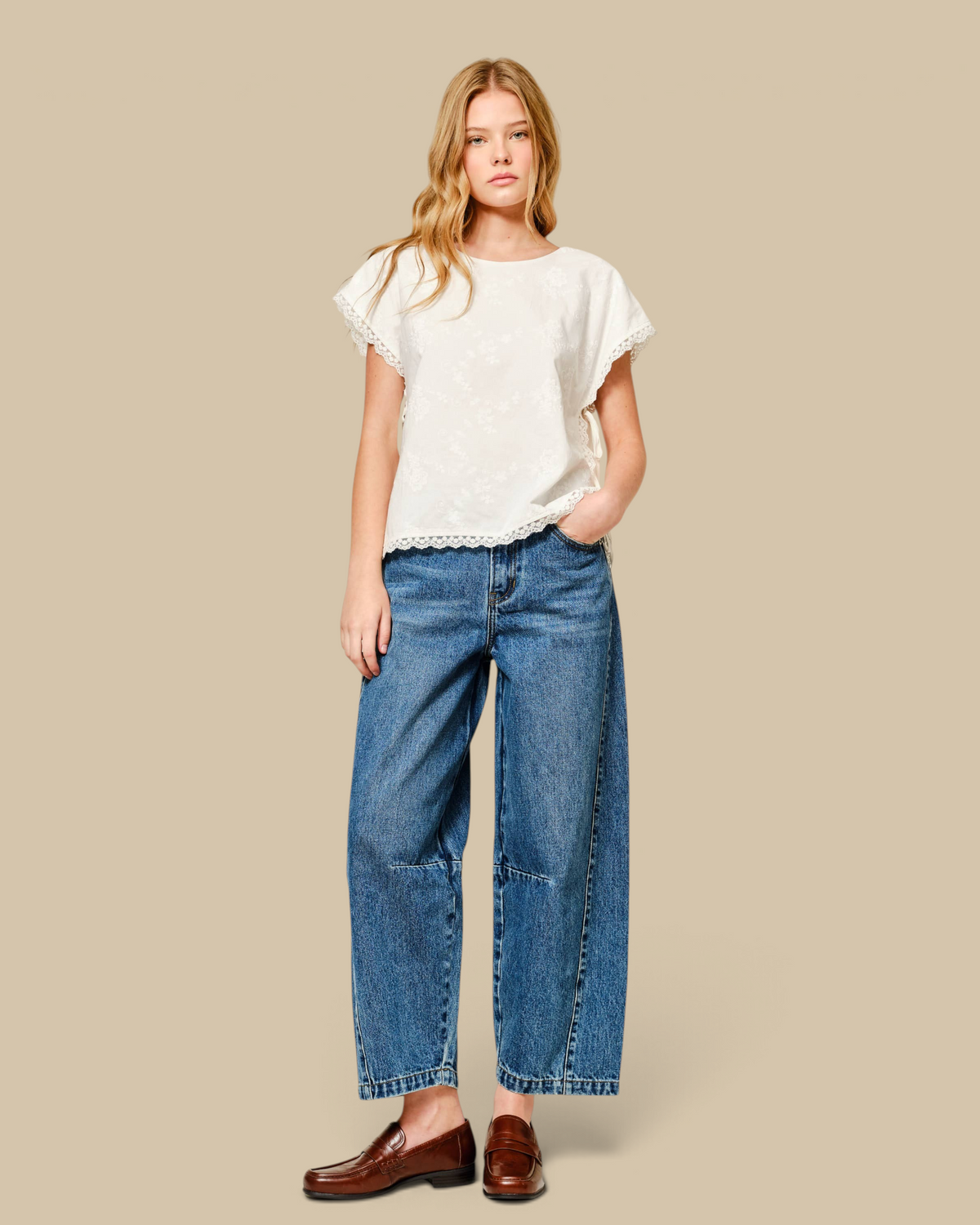Homestyle Collective mid-rise blue denim barrel jeans with seam detailing and a wide-leg cropped fit on a model.