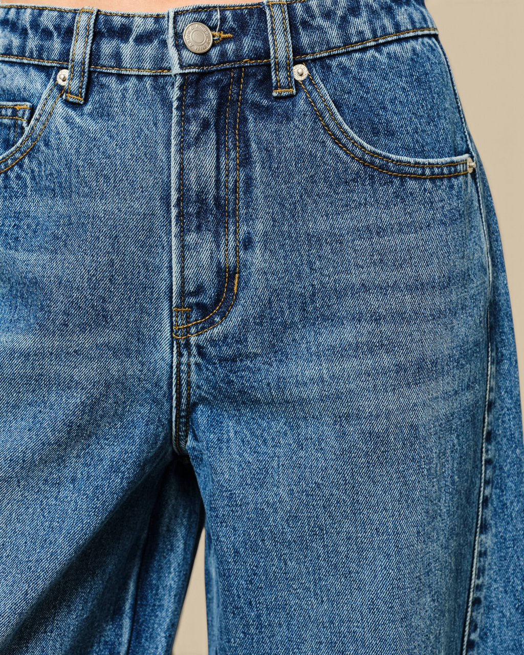 Homestyle Collective mid-rise blue denim barrel jeans with contrast stitching, belt loops, and zip fly detail.