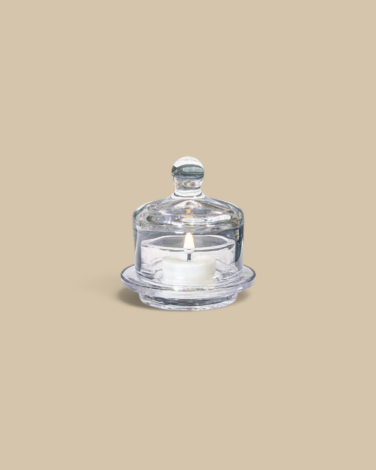 Homestyle Collective small clear glass butter dish with a domed lid, displayed on a white table.