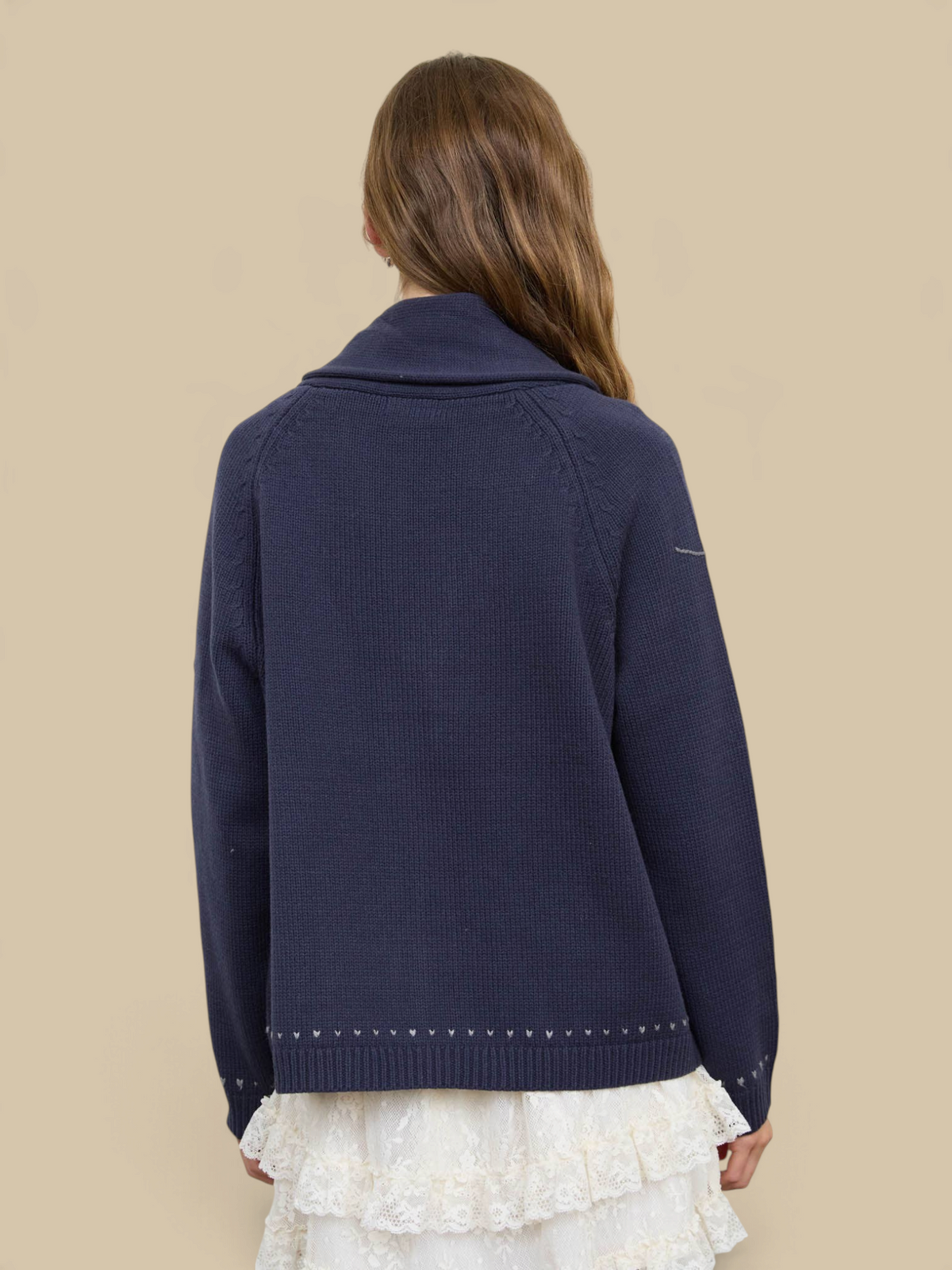 Back view of Homestyle Collective navy knit cardigan with shawl collar and subtle hem detail on a model