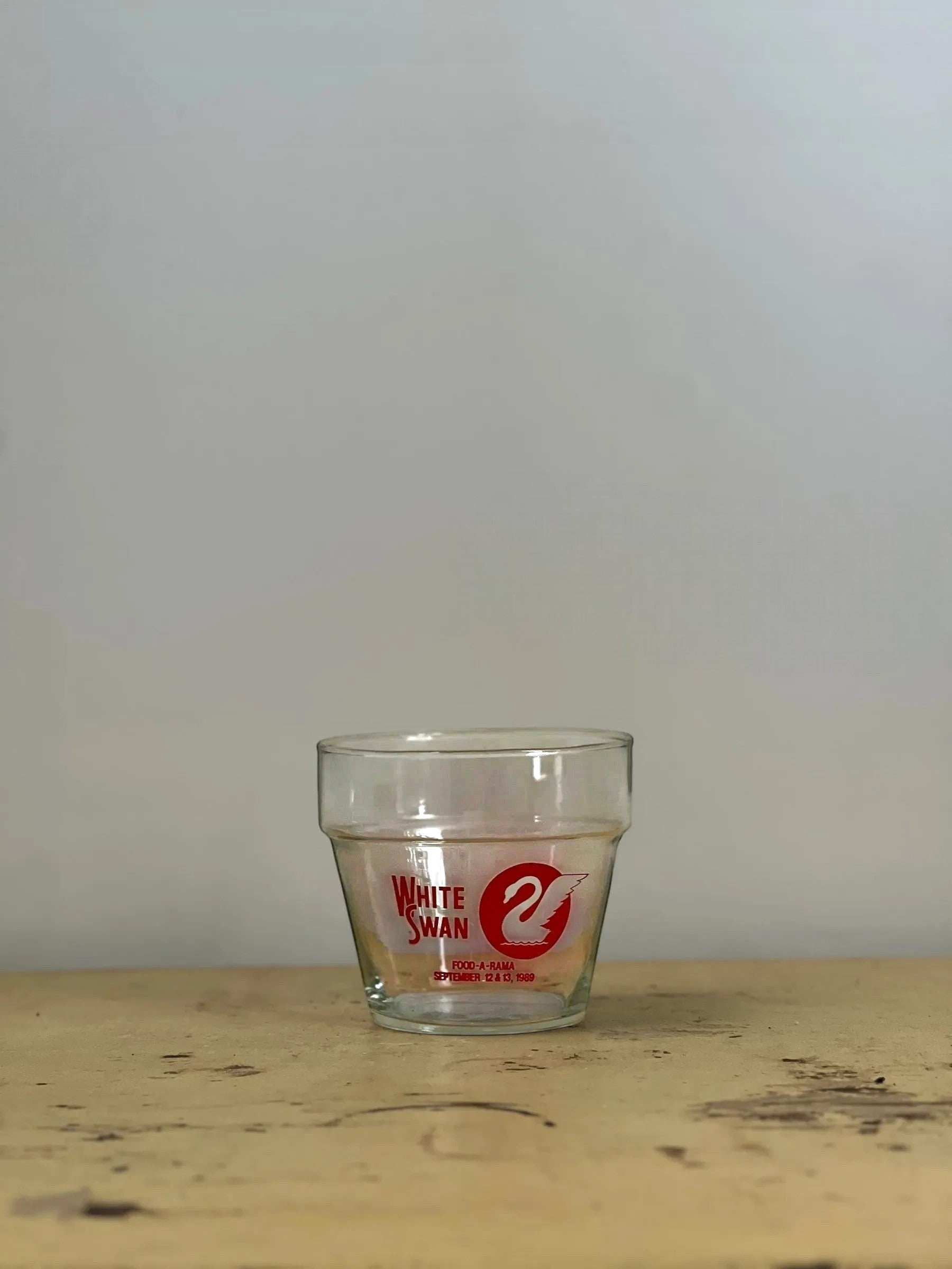 Homestyle Collective 1989 White Swan Food-A-Rama glass bowl with red logo. Clear glass, 4.5" tall x 5" wide.