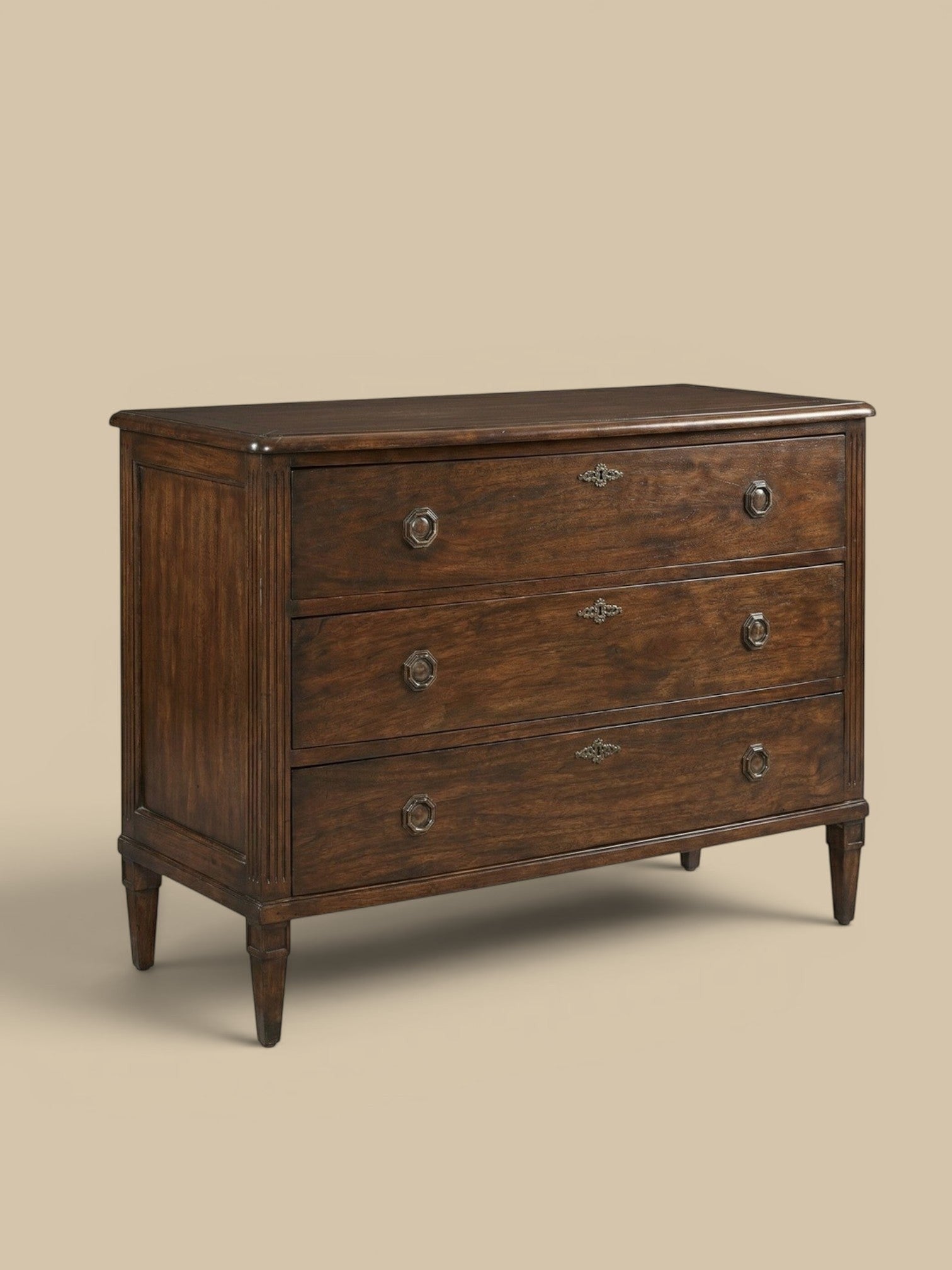 Homestyle Collective Andrews Chest, a dark brown hardwood dresser with three drawers and tarnished brass hardware, featuring fluted side panels and tapered legs.