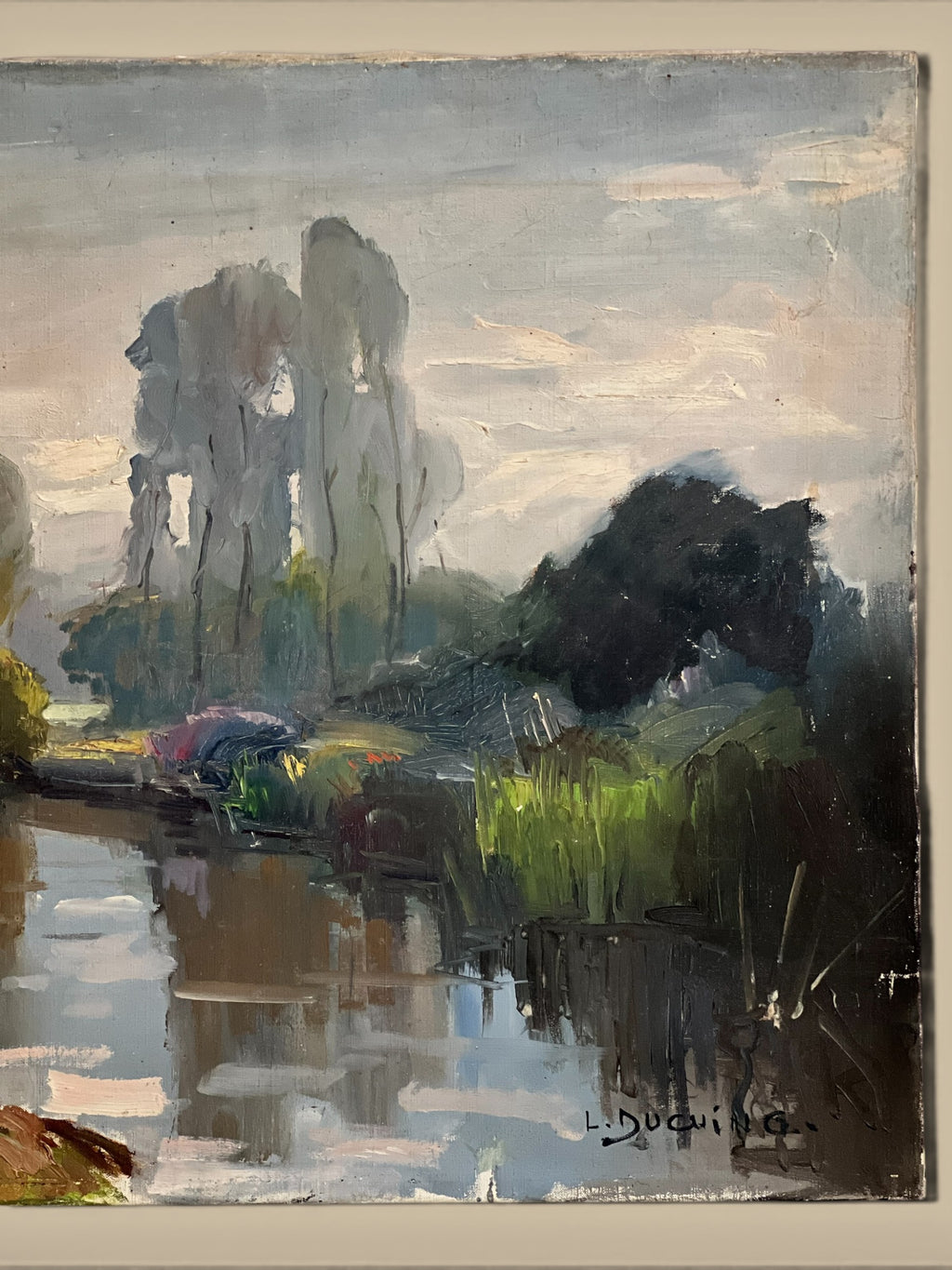 Homestyle Collective antique oil painting of a serene river landscape with tall trees and lush greenery reflected in the water.