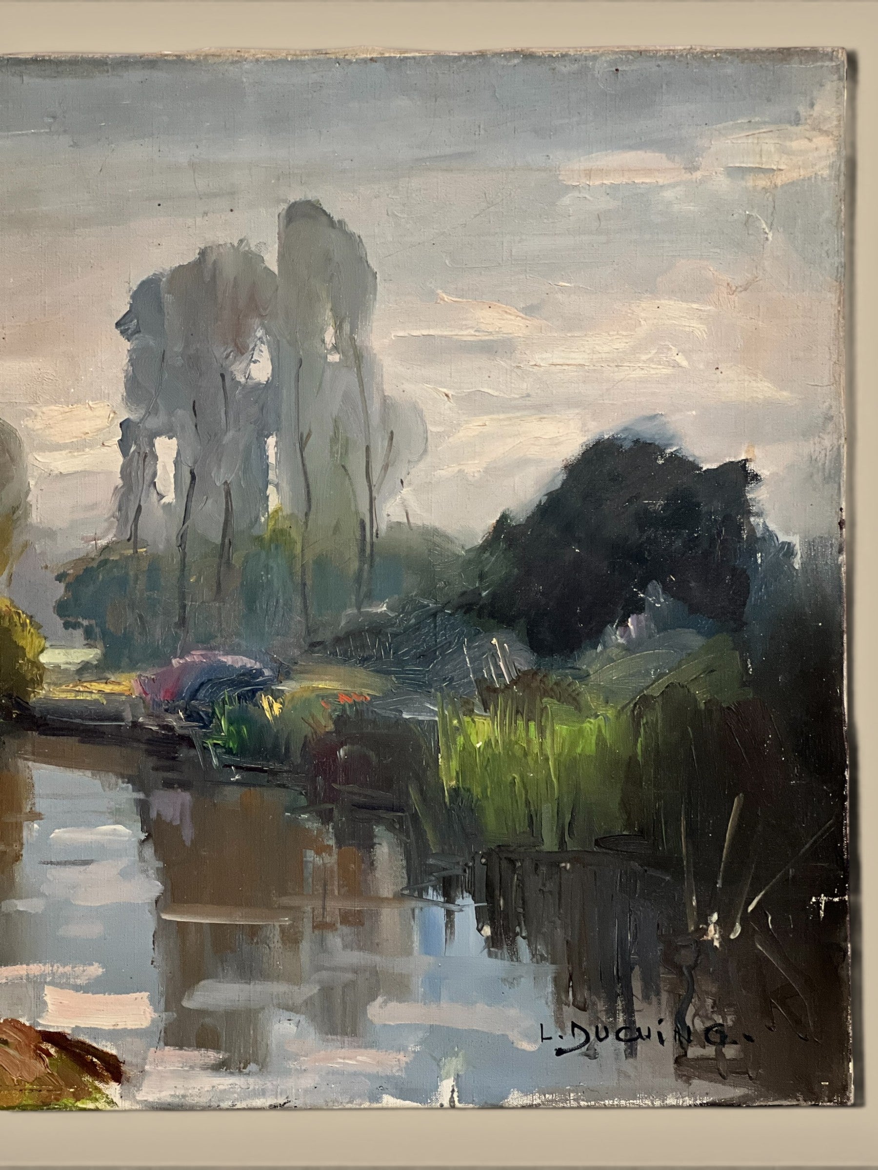 Homestyle Collective antique oil painting of a serene river landscape with tall trees and lush greenery reflected in the water.