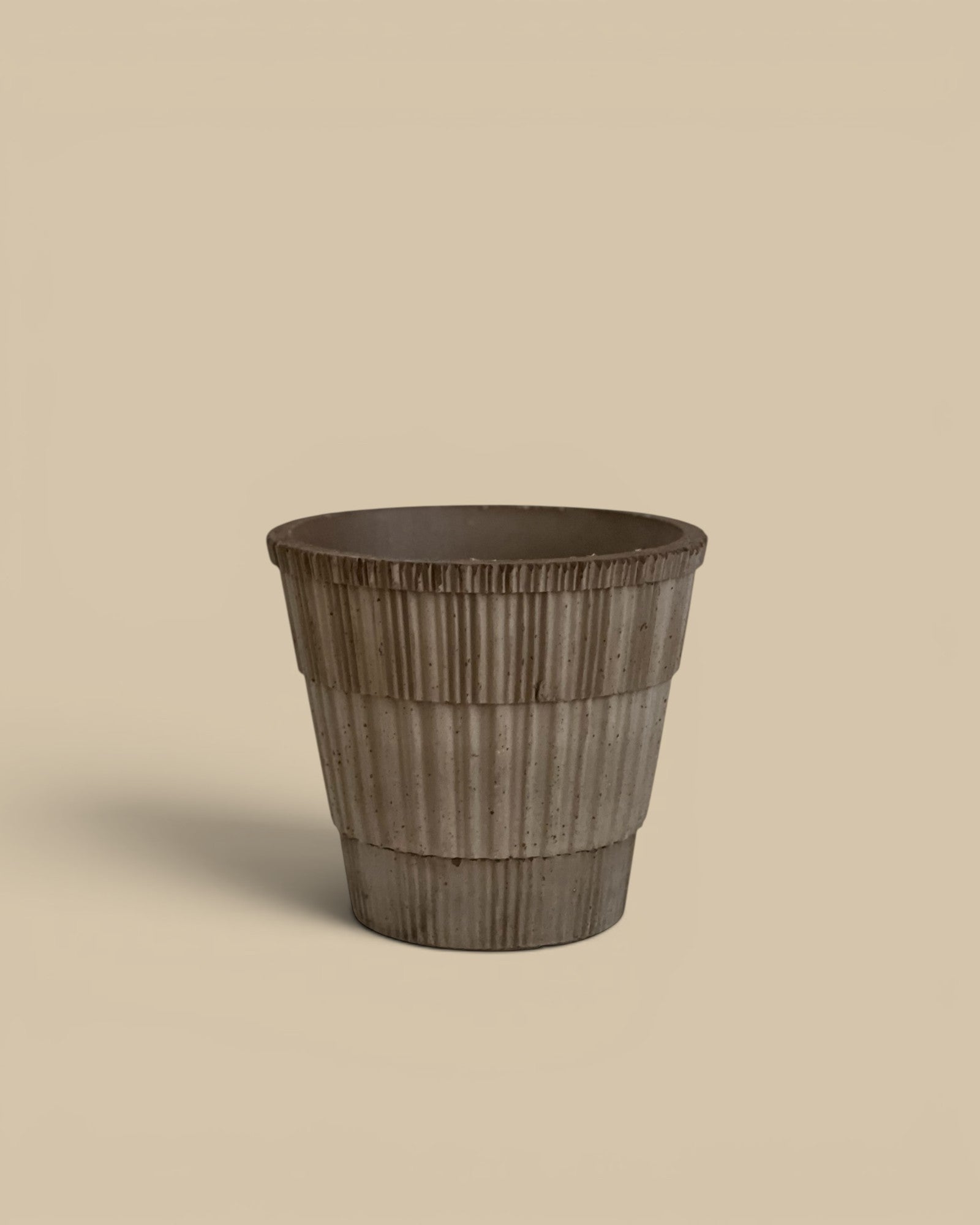 Homestyle Collective Atlas terracotta pot in raw grey with ribbed texture and matching saucer. 7.1" x 6.7" H.