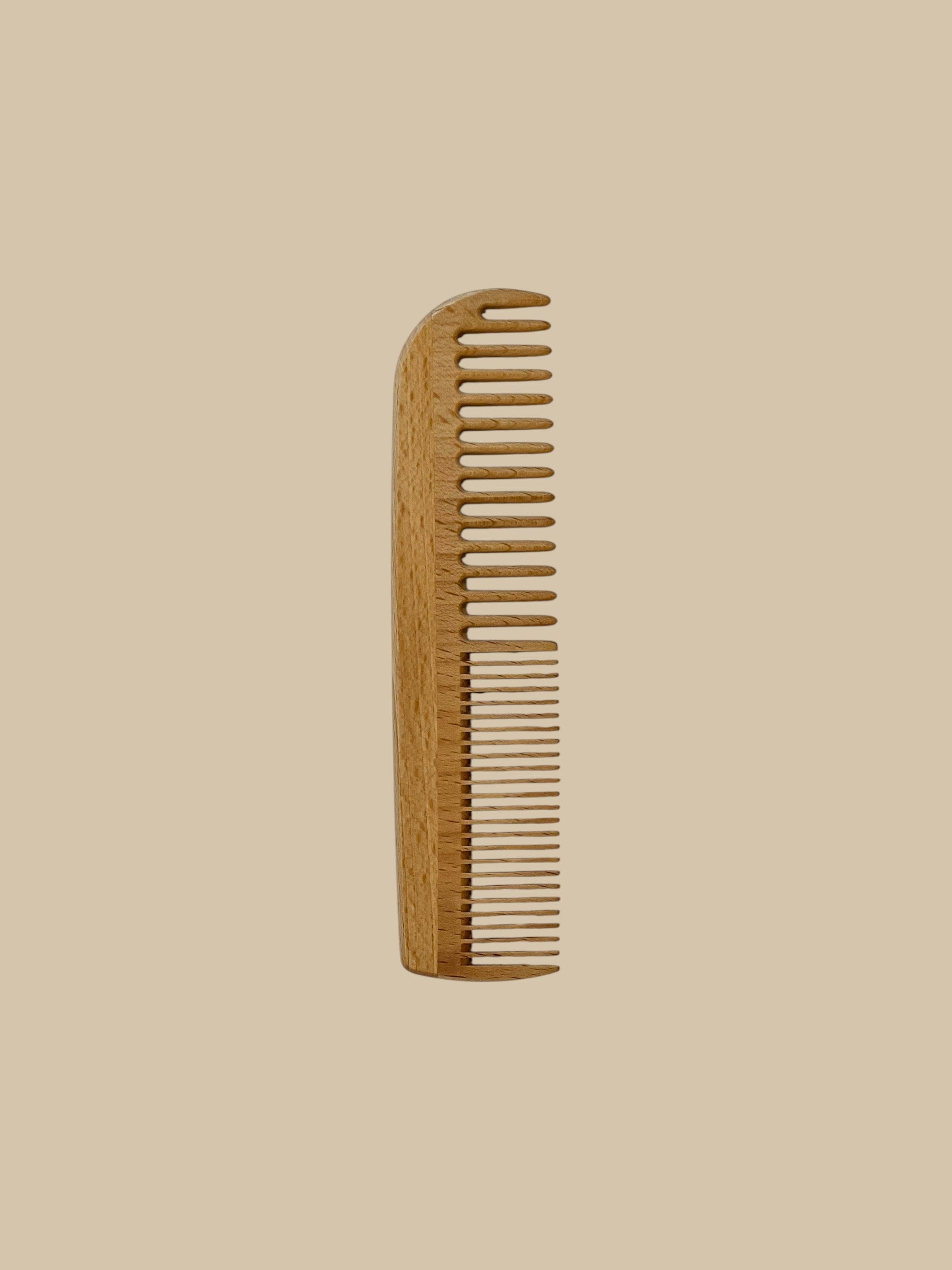 Homestyle Collective 7" beechwood comb with wide and fine teeth for detangling and styling.