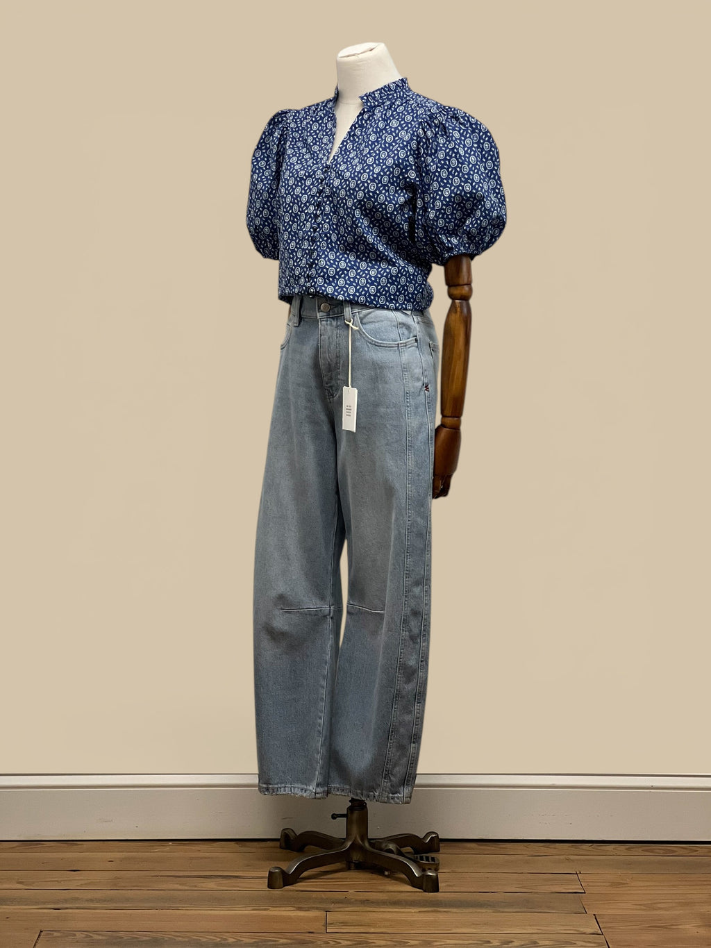 Homestyle Collective blue floral print blouse with V-neck, ruffled collar, and balloon sleeves.
