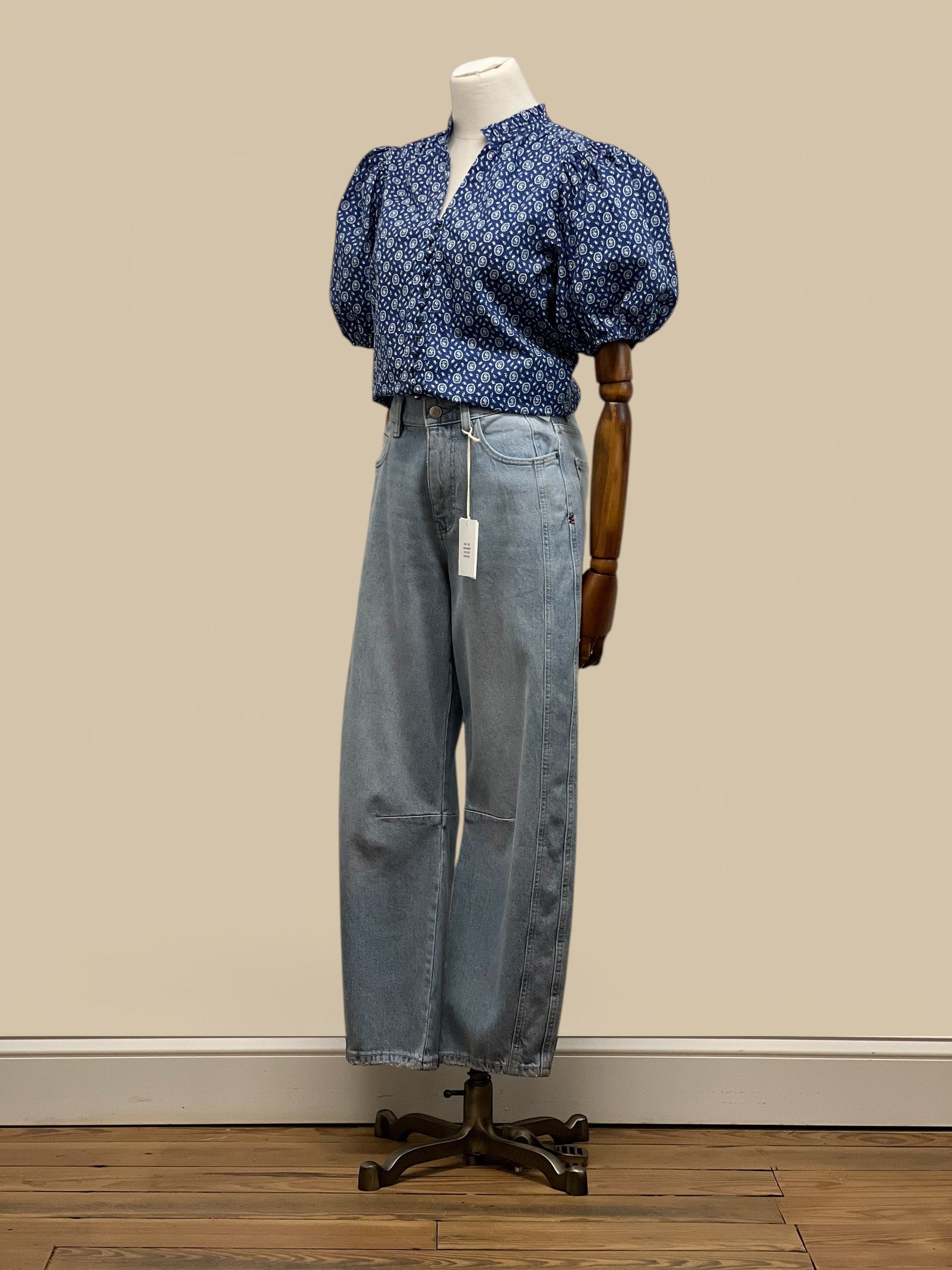 Homestyle Collective blue floral print blouse with V-neck, ruffled collar, and balloon sleeves.