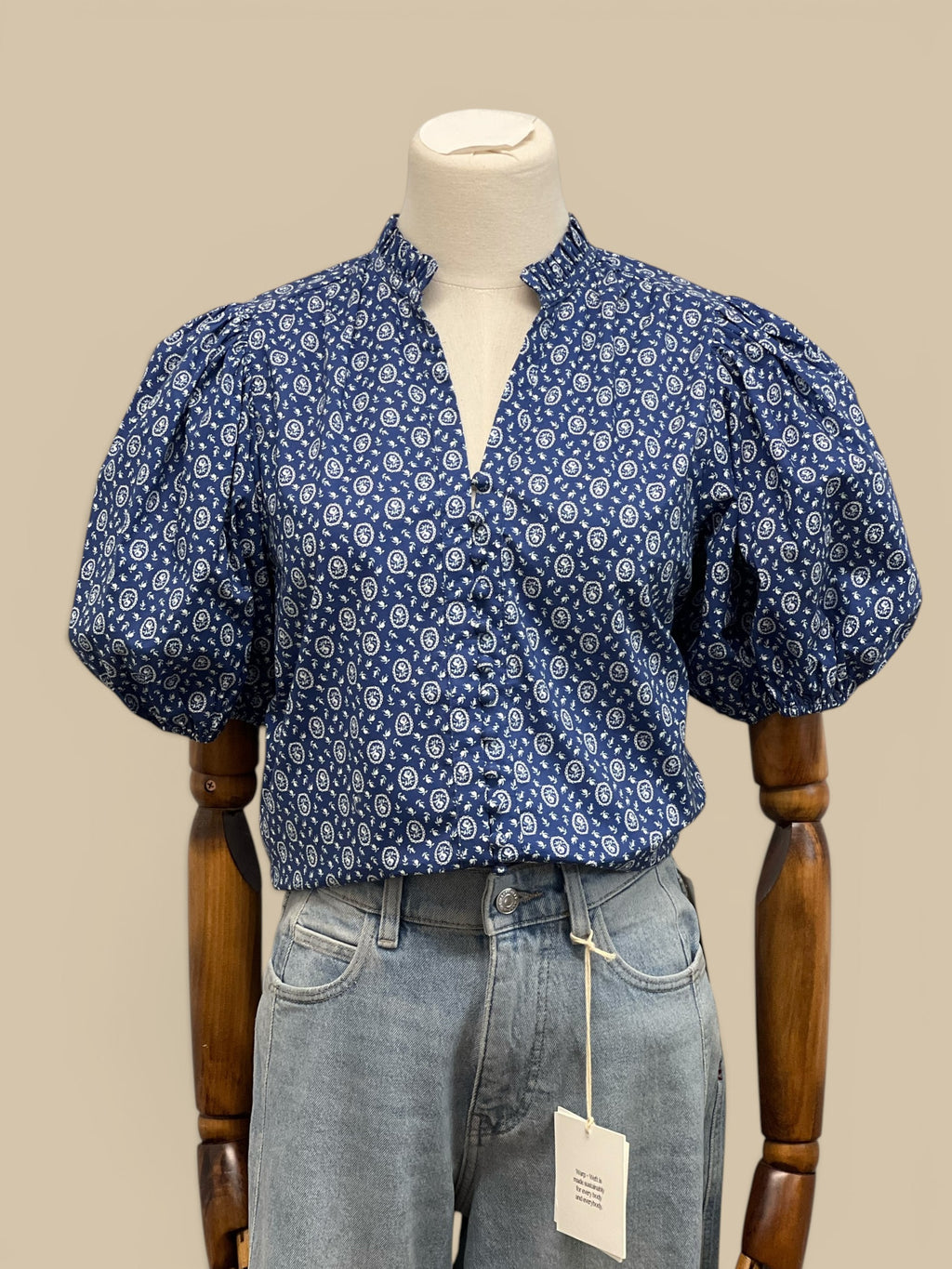 Homestyle Collective blue floral print blouse with ruffled V-neck, balloon sleeves, and elastic cuffs.