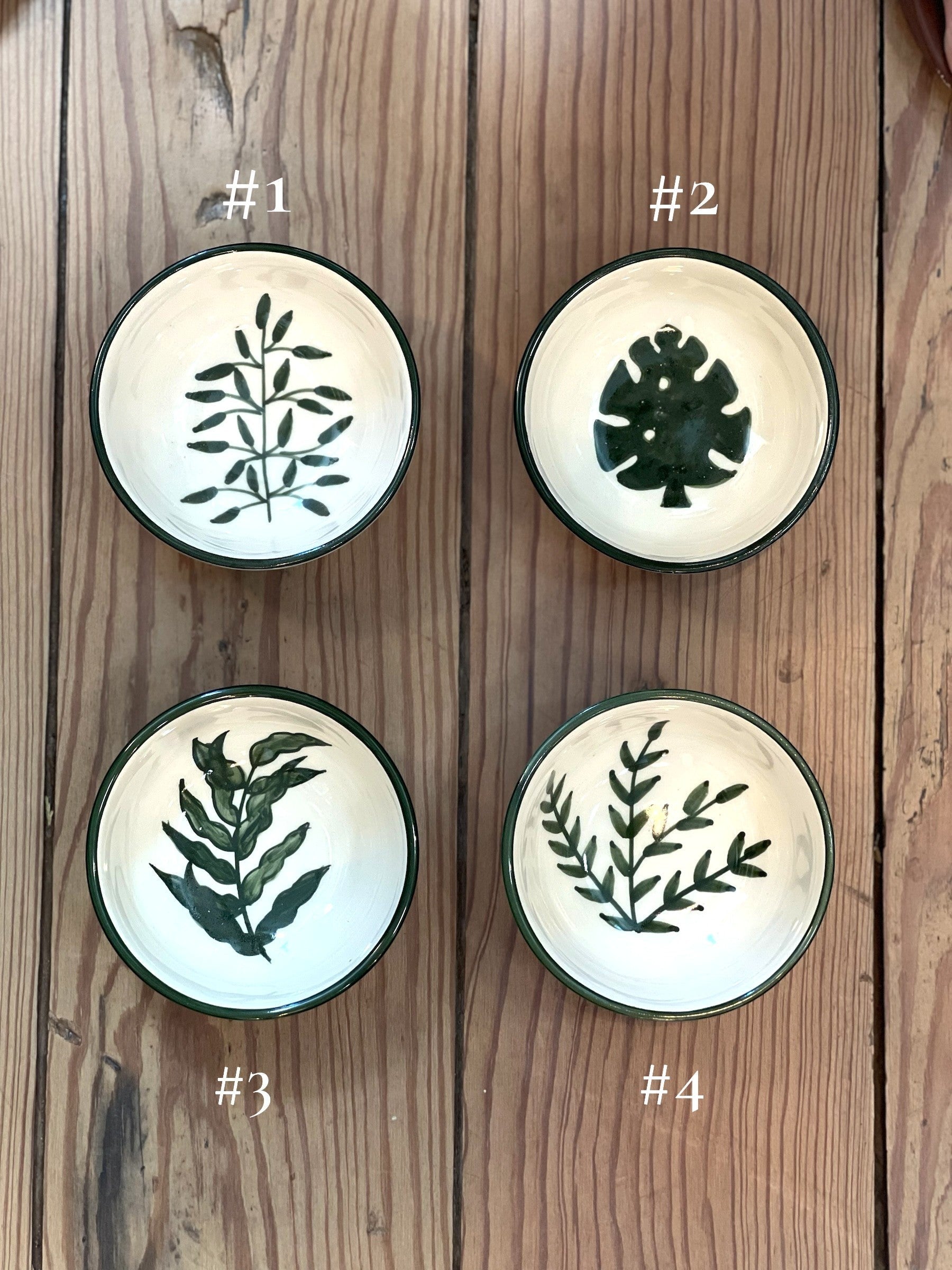 Homestyle Collective botanical stoneware bowls with hand-painted green leaf designs and coordinating rims. Set of four.