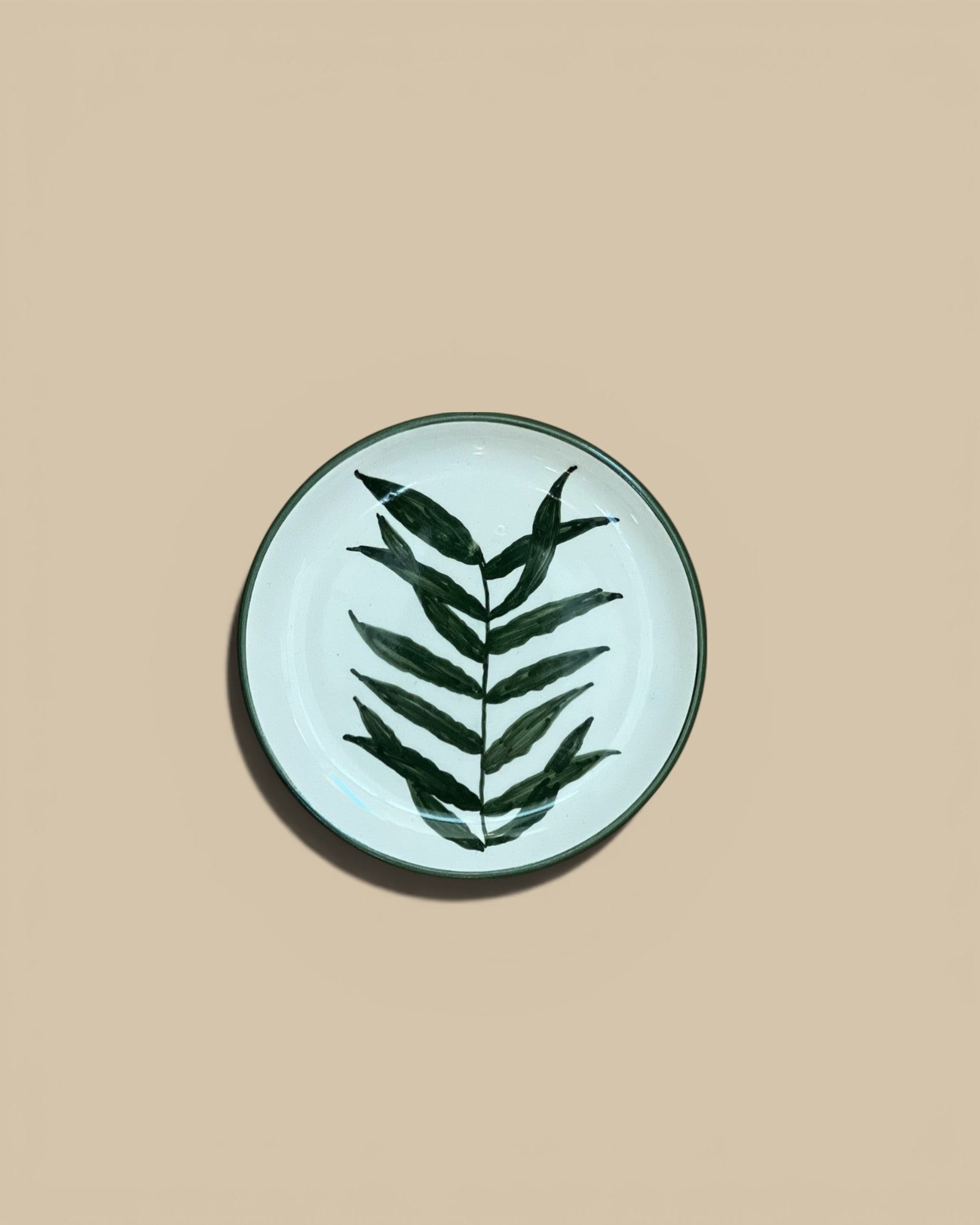 Homestyle Collective 5" round stoneware plate with hand-painted dark green botanical leaf design on cream background.