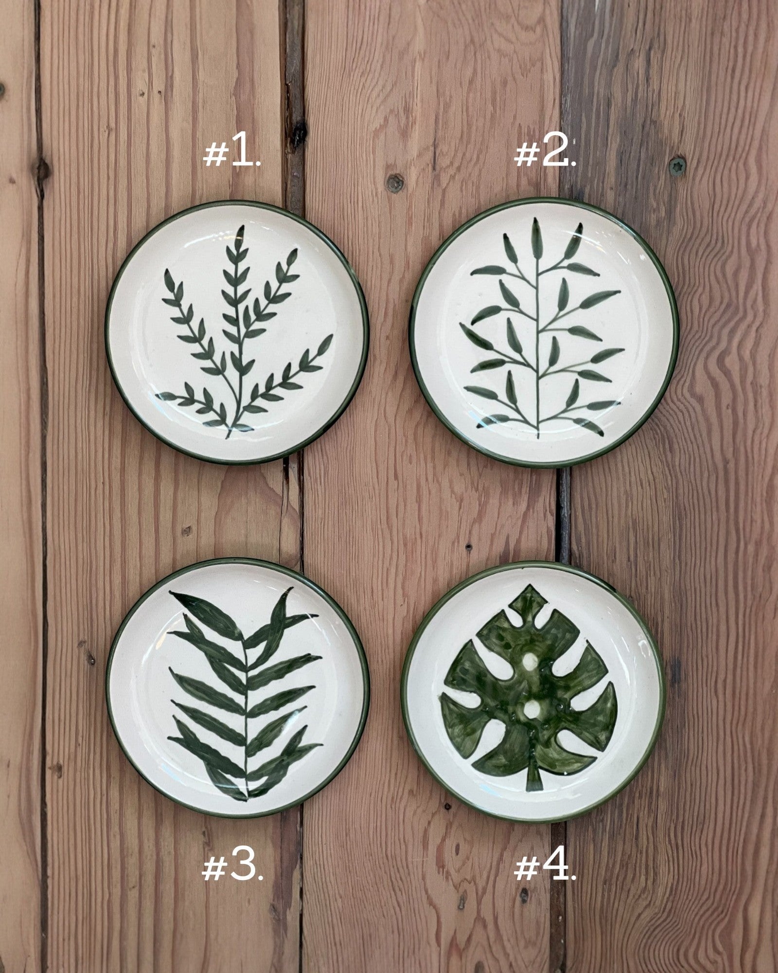 Homestyle Collective botanical stoneware plates, cream with dark green hand-painted leaf designs. Set of 4 styles.