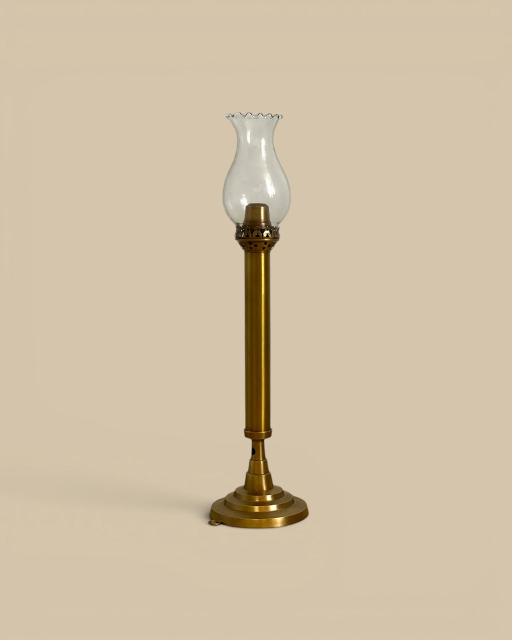 Homestyle Collective brass taper candle holder with glass hurricane shade and spring-loaded mechanism. Vintage style.