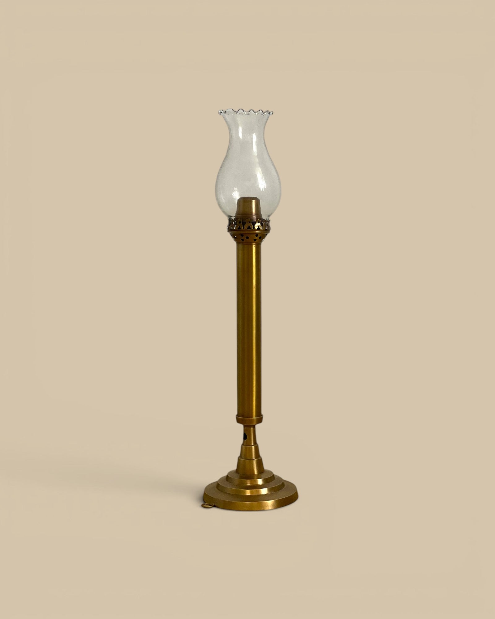 Homestyle Collective brass taper candle holder with glass hurricane shade and spring-loaded mechanism. Vintage style.
