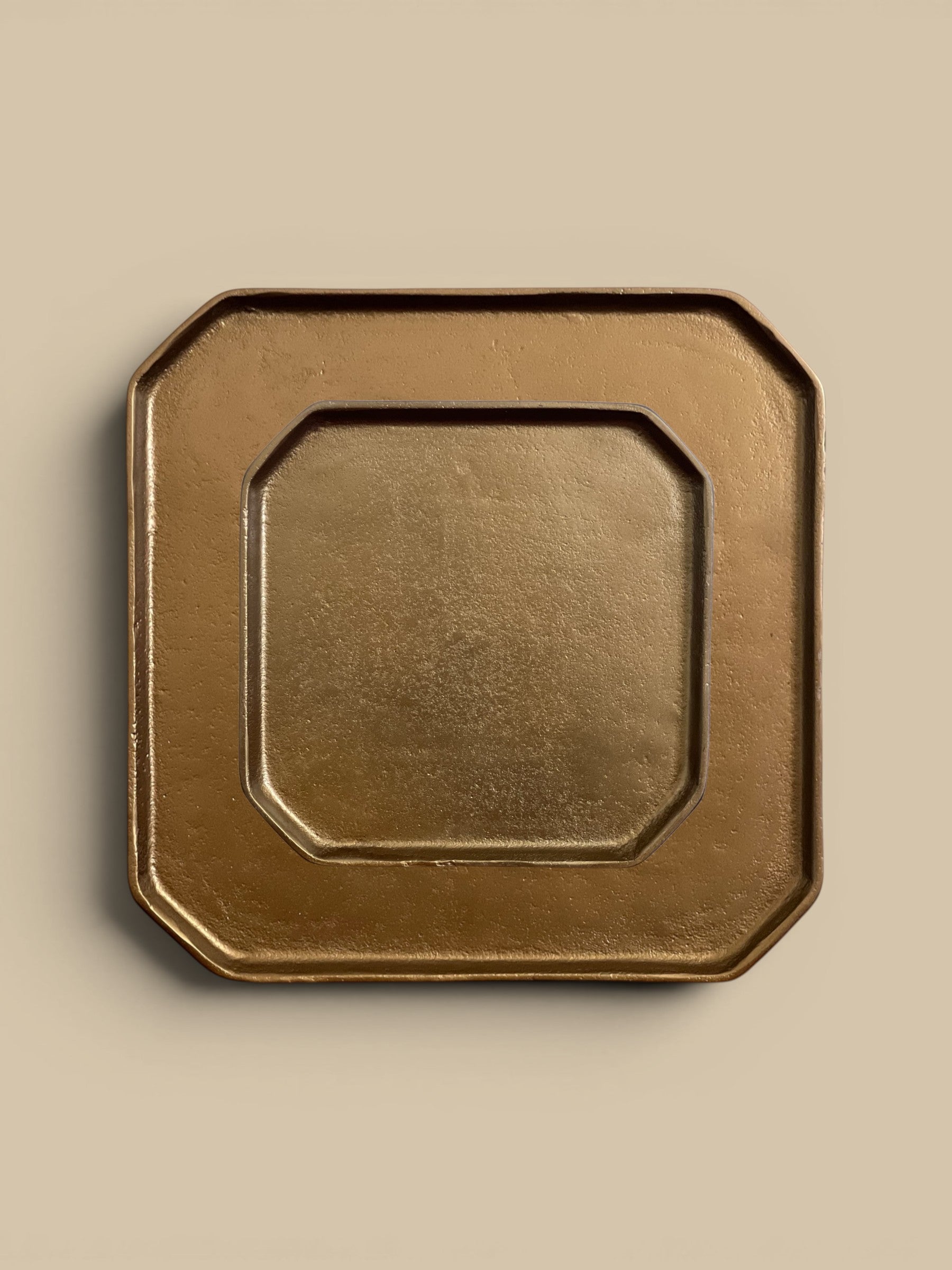 Homestyle Collective brass aluminum tray, octagonal shape with beveled edges, versatile for decor or serving.