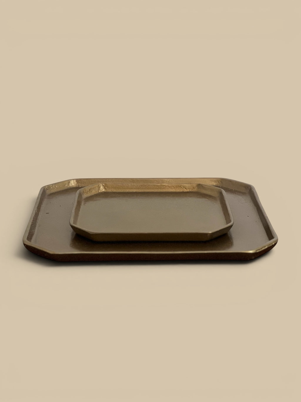 Homestyle Collective brass-plated aluminum trays, one large and one small, with a subtle modern elegance.
