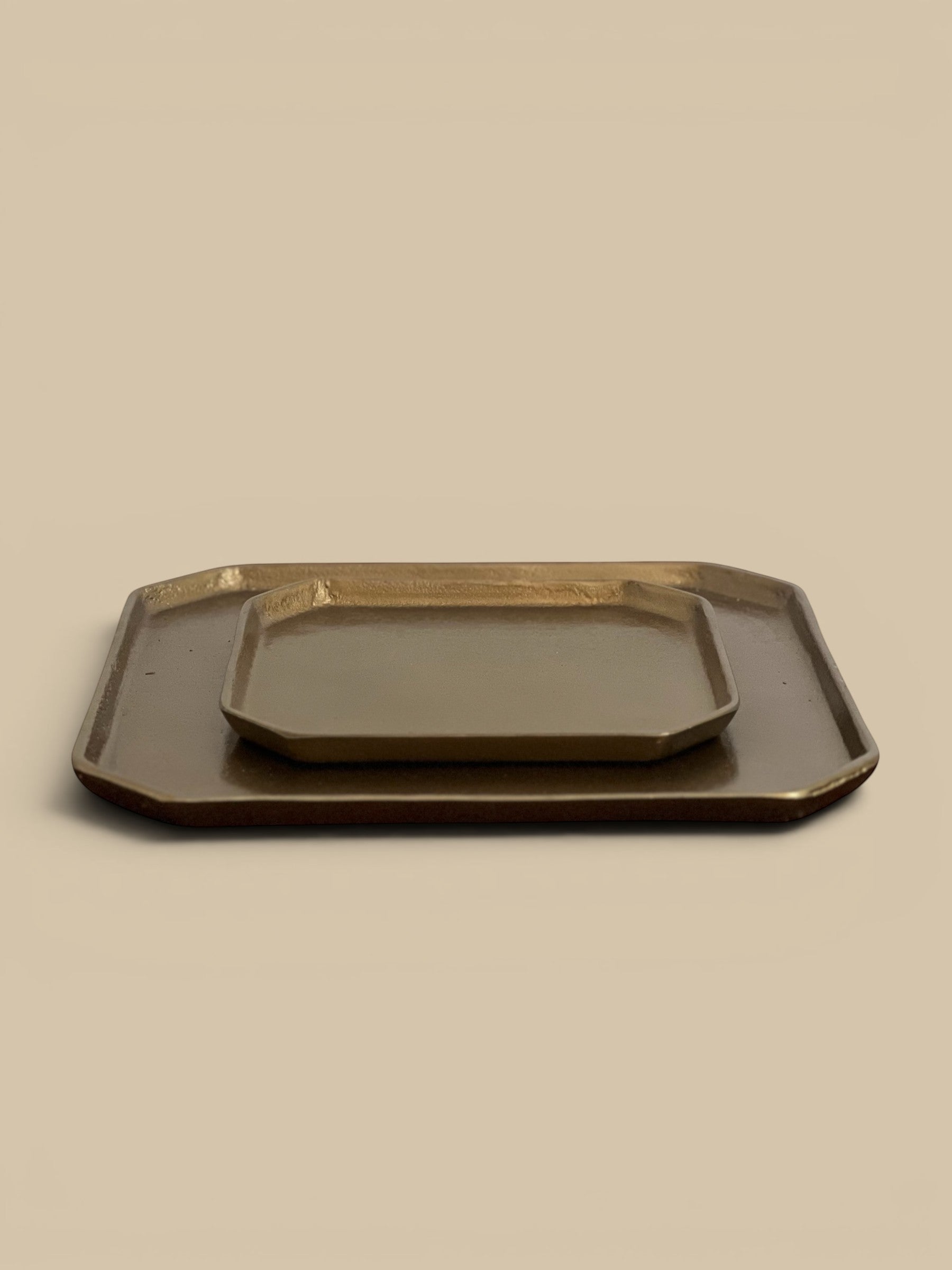 Homestyle Collective brass-plated aluminum trays, one large and one small, with a subtle modern elegance.