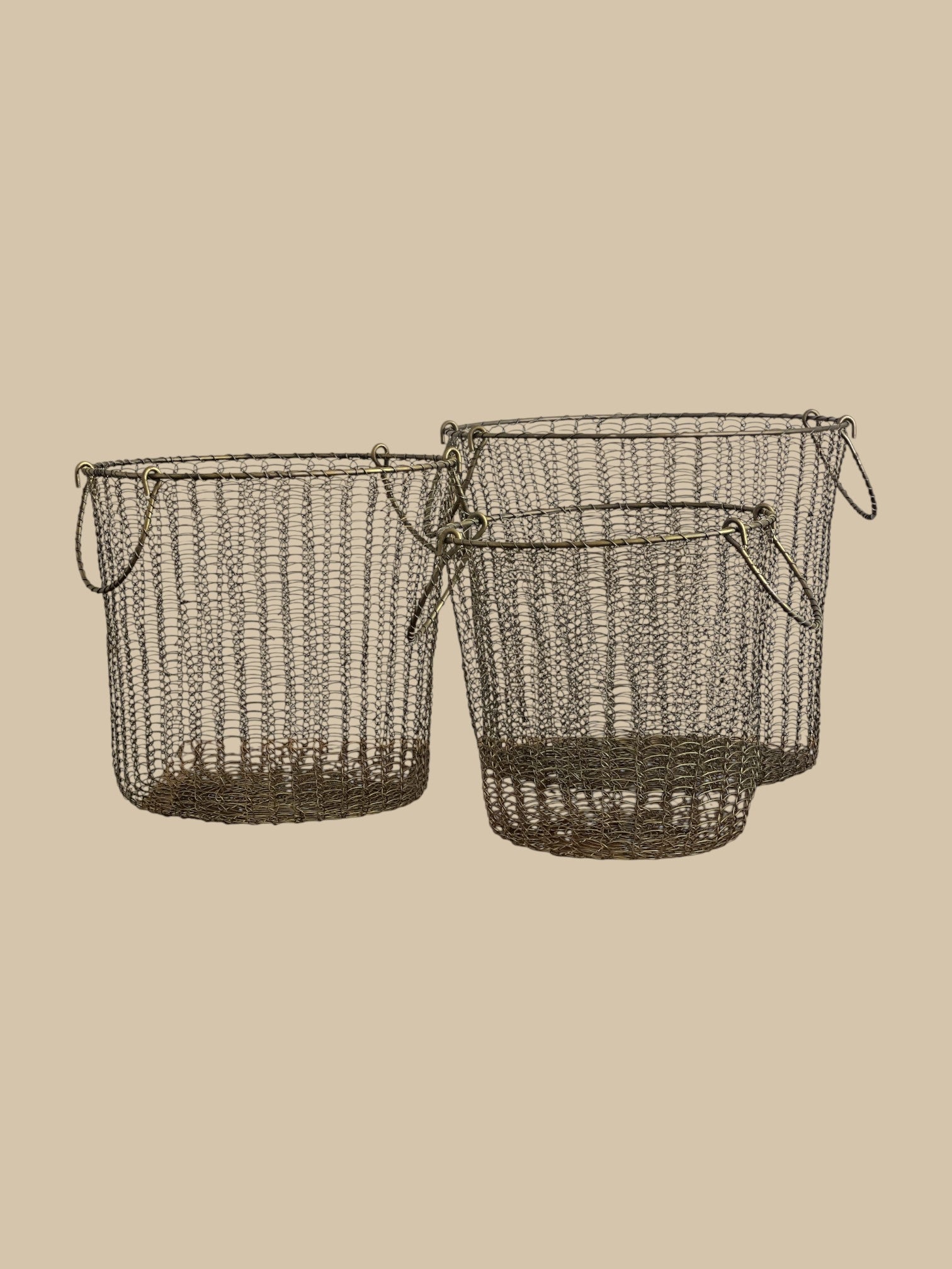 Homestyle Collective Moana brass wire baskets, set of 3, with handles. Open weave design.
