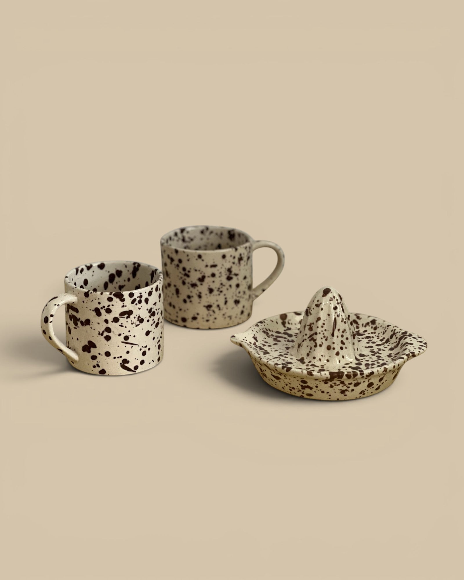 Homestyle Collective Cacao Splatterware Juicer, a speckled stoneware citrus juicer with a ridged cone and catch-dish.