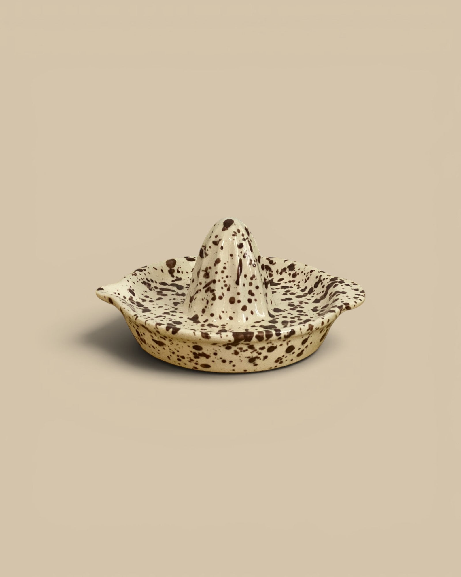 Homestyle Collective Cacao Splatterware Juicer, a speckled stoneware citrus juicer with a ridged cone and wide catch-dish.