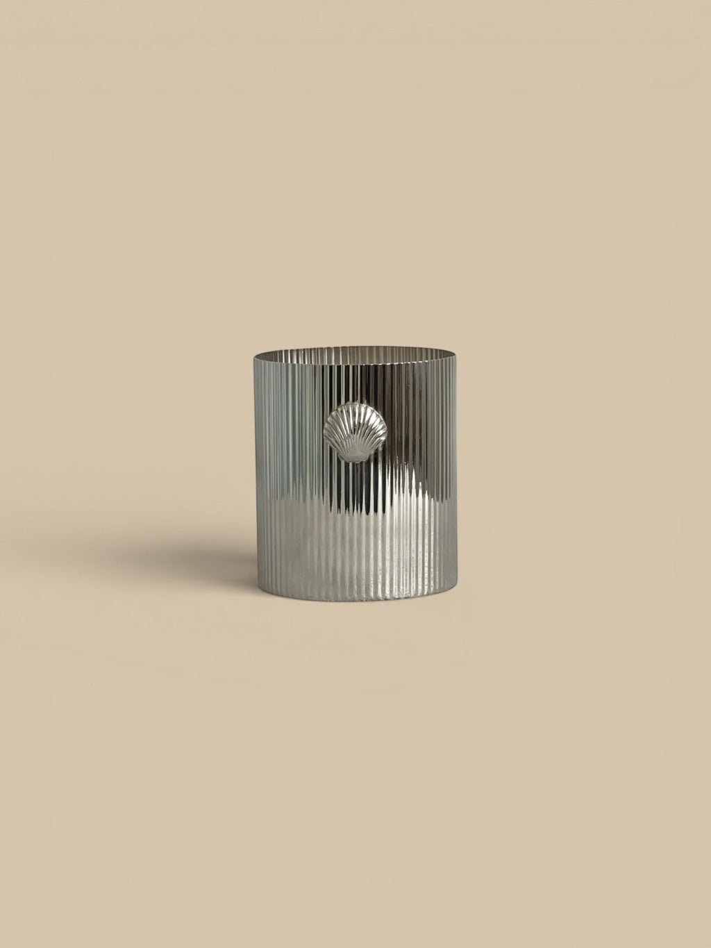 Homestyle Collective Cap Ferrat Shell Candle in Sea Salt scent. Silver ribbed vessel with a shell accent.