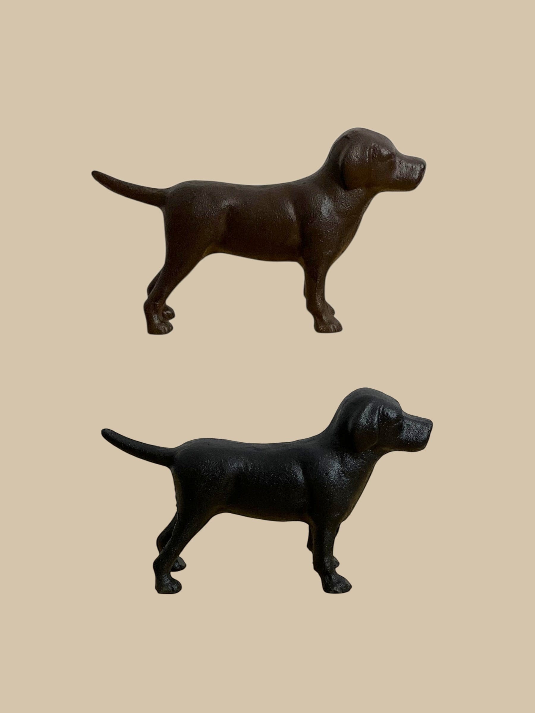 Homestyle Collective cast iron Labrador dog figurines in black and rust brown finishes standing on a neutral background.