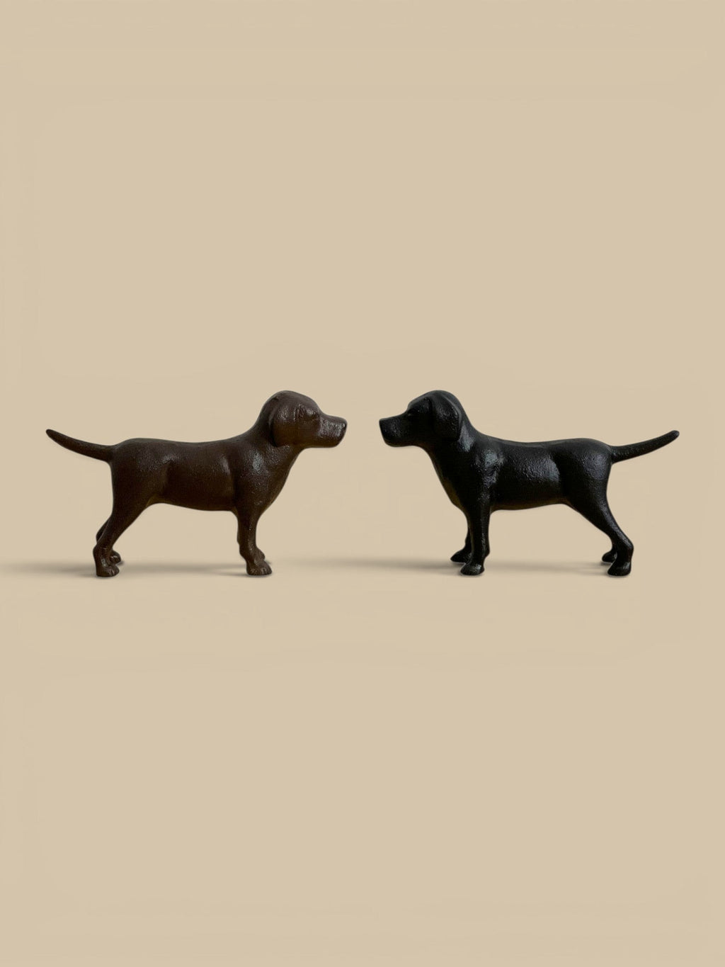 Homestyle Collective cast iron Labrador figurines in black and rust brown finishes for home decor.