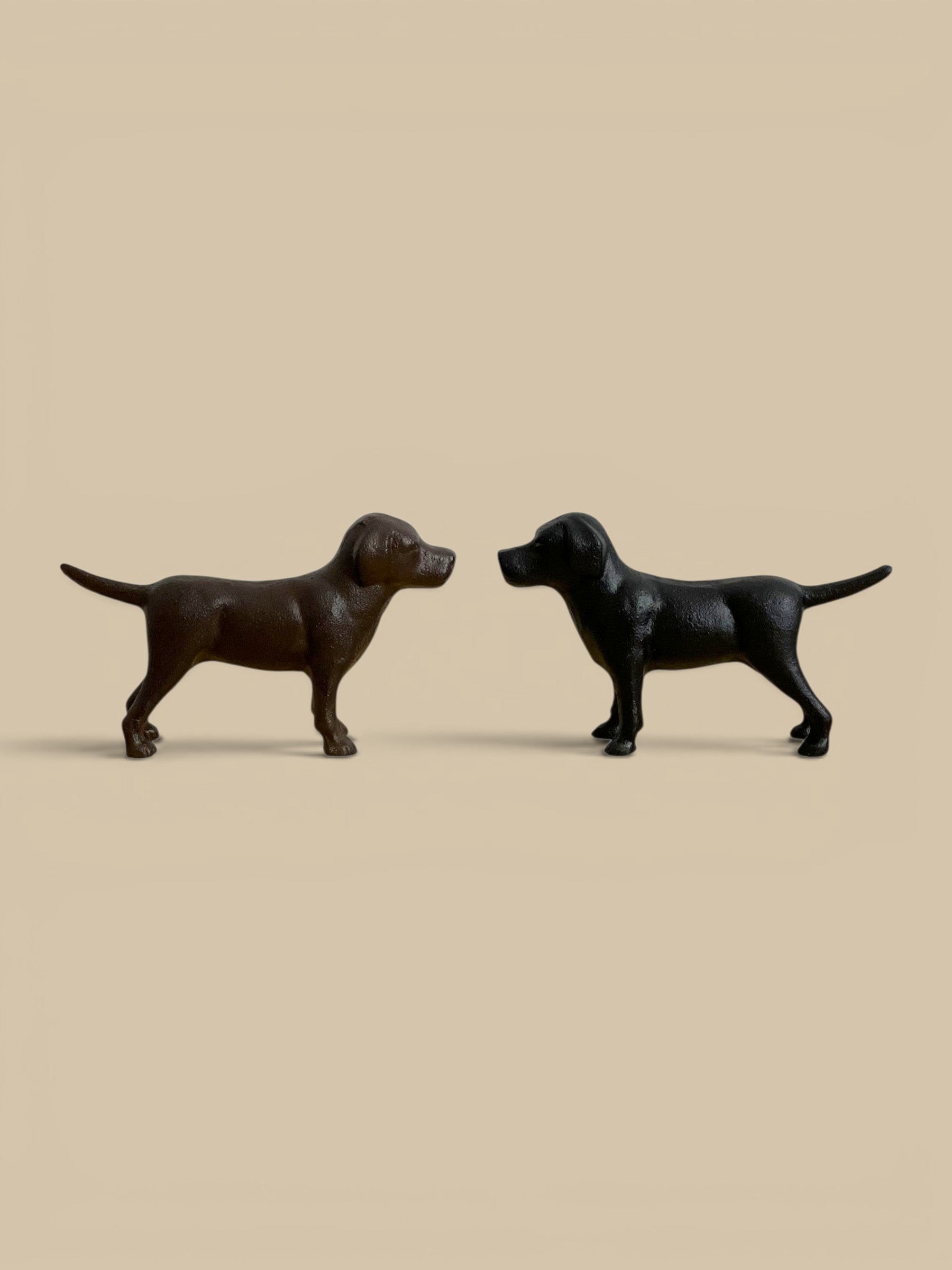 Homestyle Collective cast iron Labrador figurines in black and rust brown finishes for home decor.
