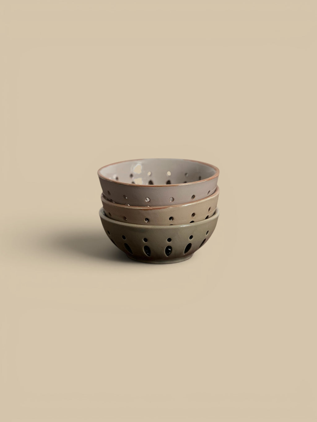 Homestyle Collective stack of three ceramic colander bowls in cream, sand, and green/grey, 5" round x 2"H.