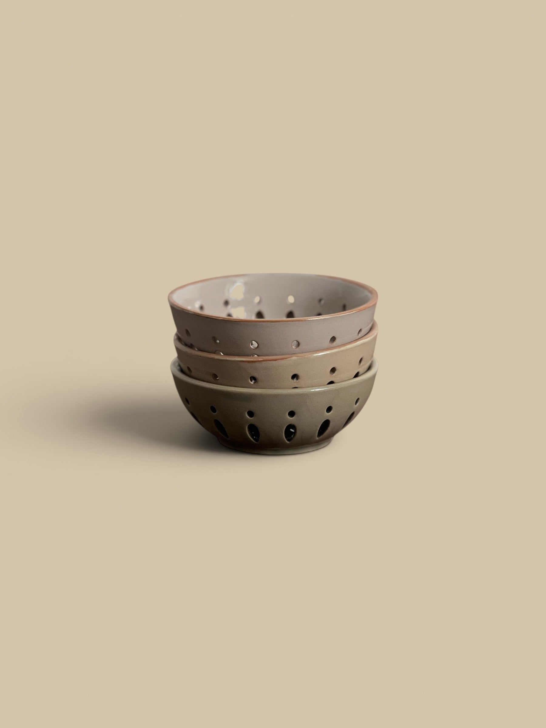 Homestyle Collective stack of three ceramic colander bowls in cream, sand, and green/grey, 5" round x 2"H.