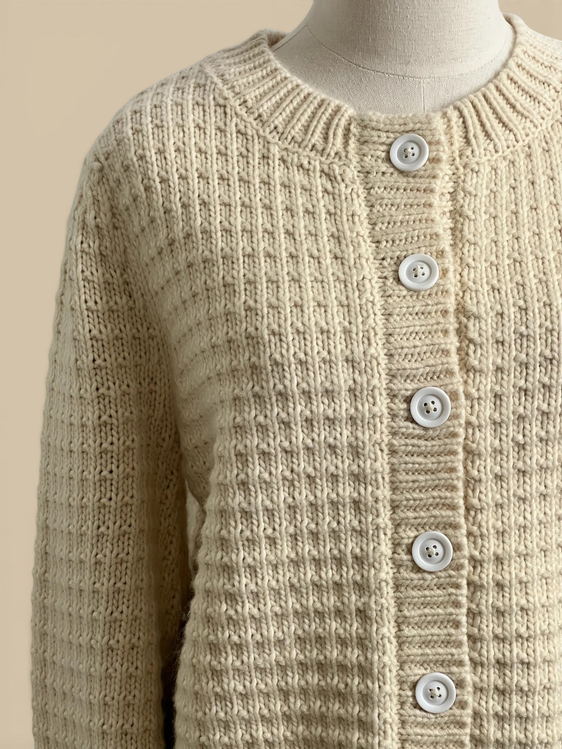 Homestyle Collective cream chunky knit cardigan with white buttons and ribbed detailing. 80% acrylic, 20% wool.