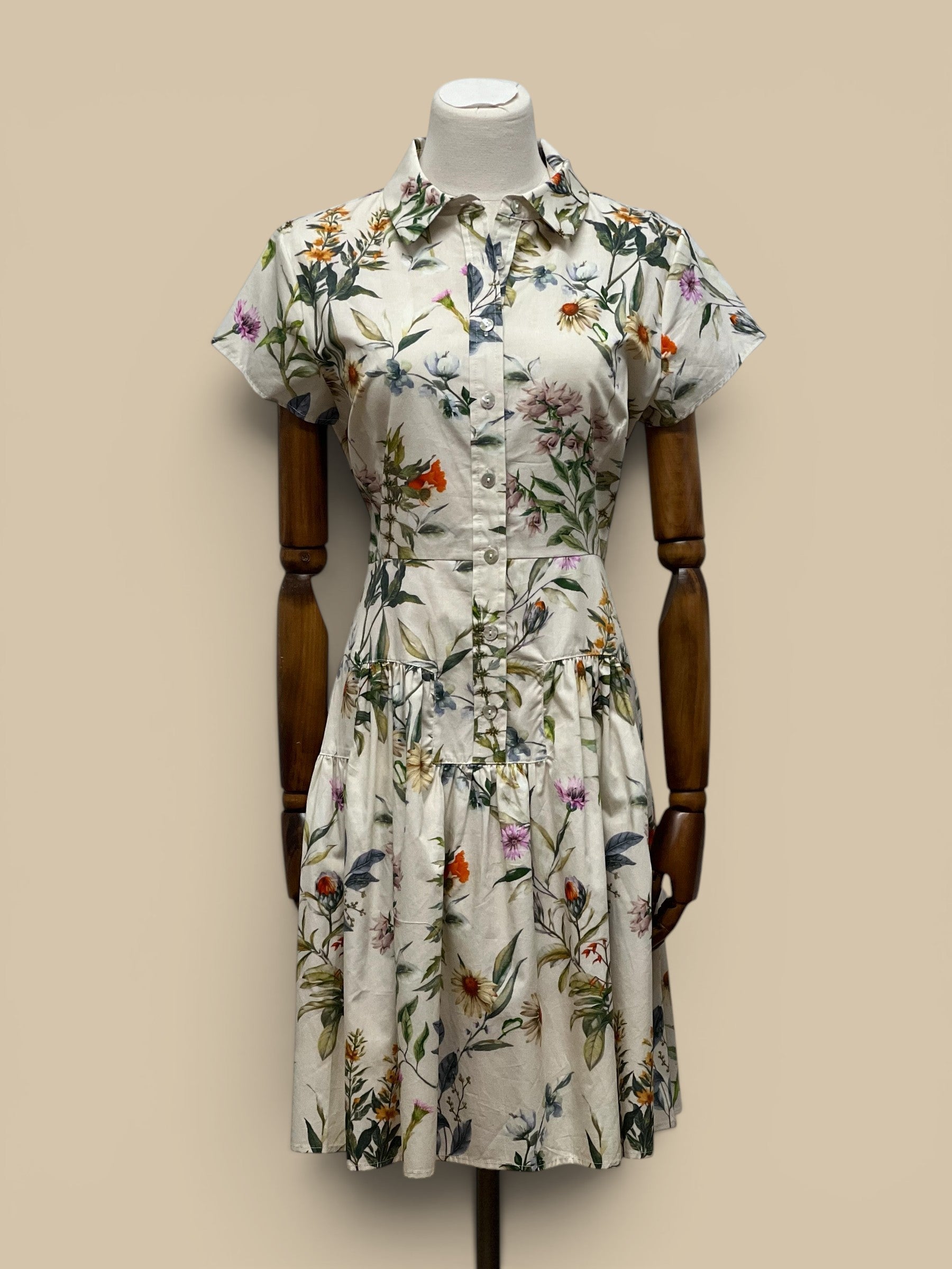 Homestyle Collective Collette Dress: cream floral print shirt dress with short sleeves and tiered skirt.