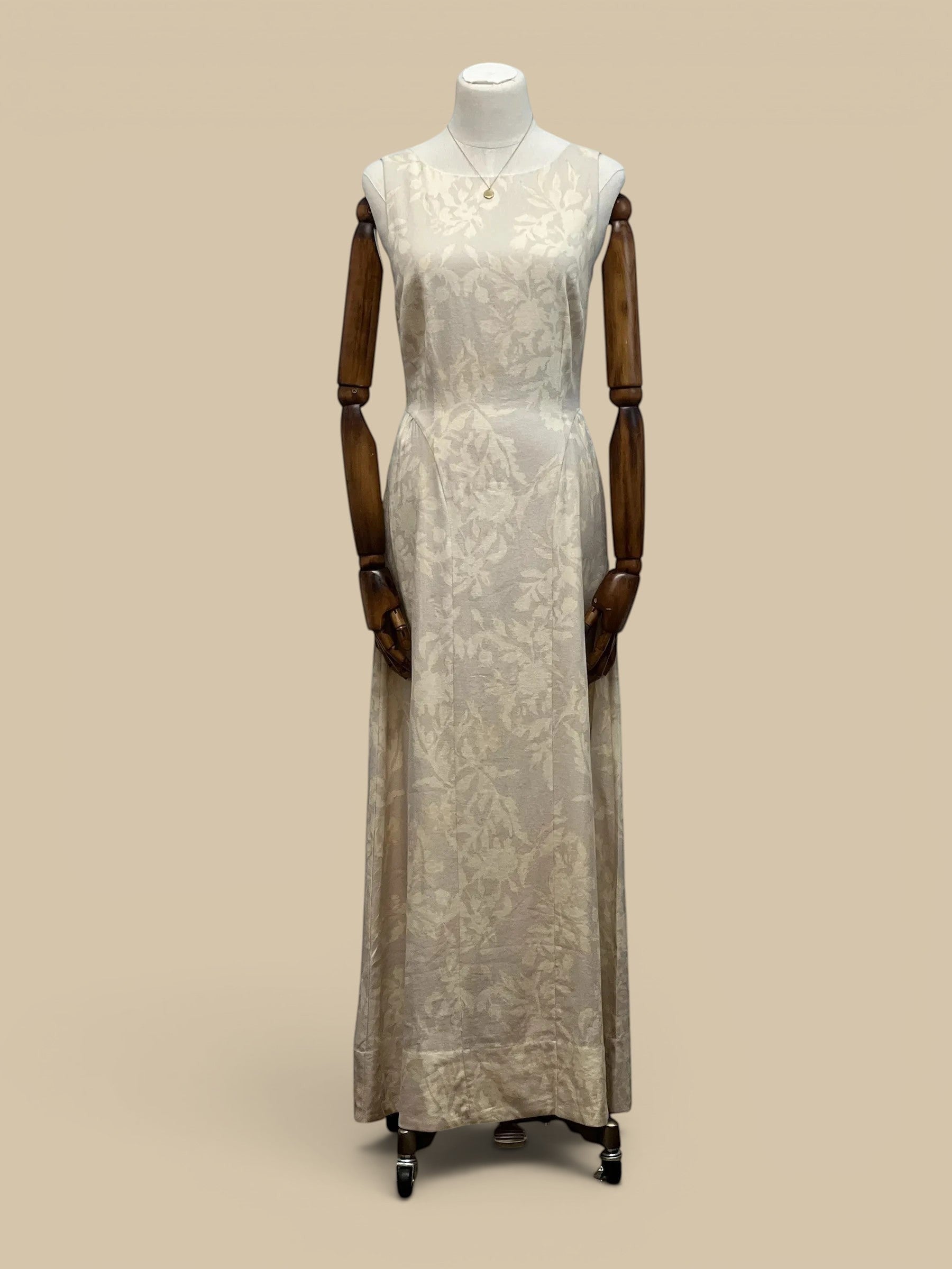 Homestyle Collective cream linen maxi dress featuring a subtle tone-on-tone floral pattern and a sleeveless silhouette.