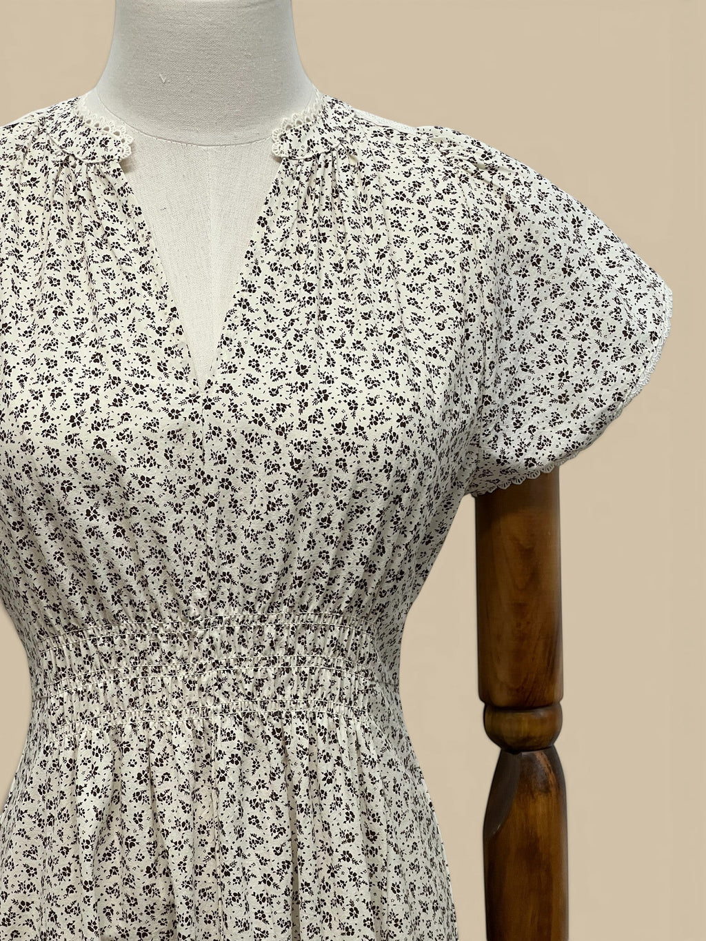 Homestyle Collective ivory cotton midi dress with brown ditzy floral print, smocked waist, and scallop lace trim.