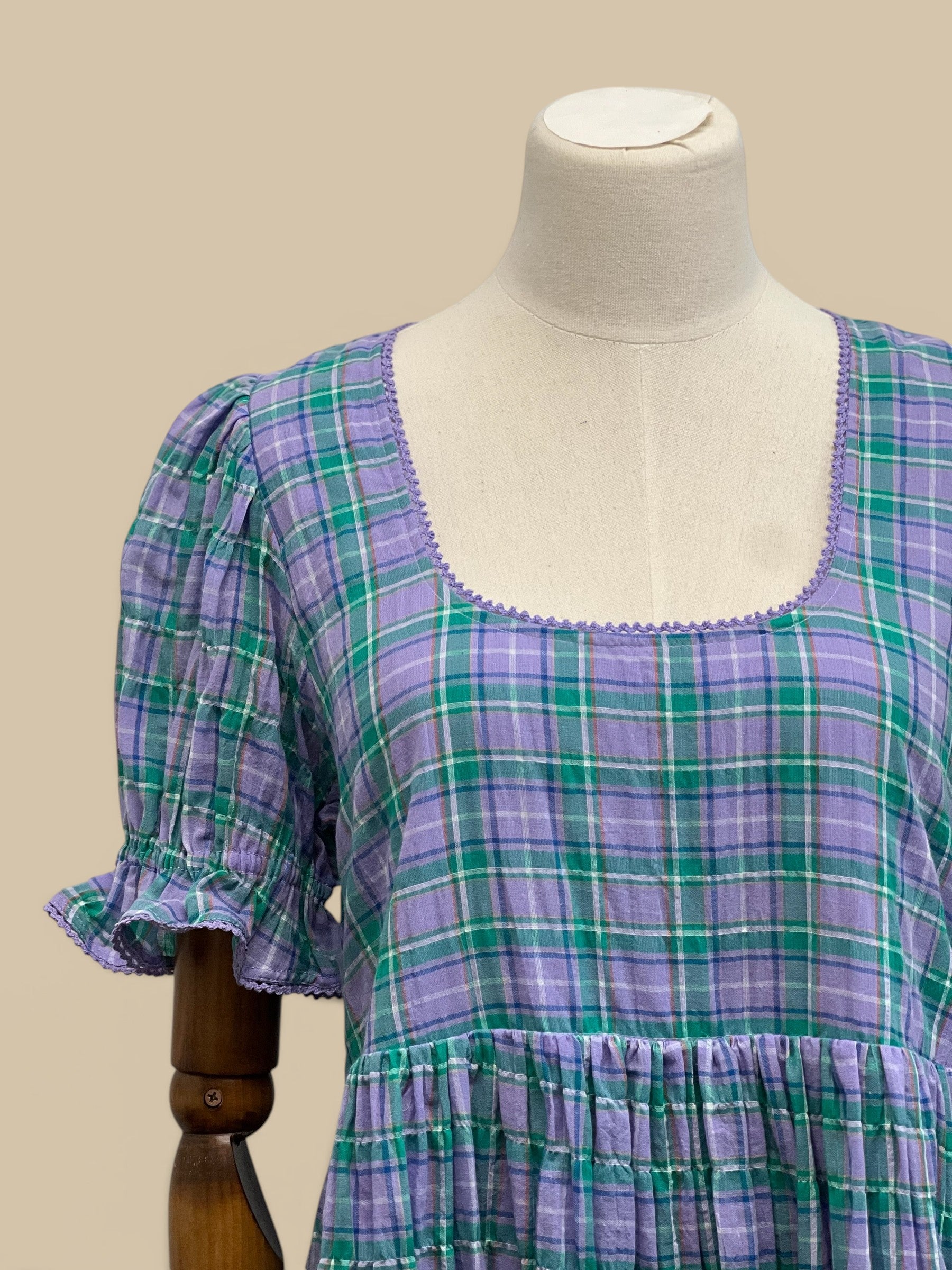 Homestyle Collective Dottie Babydoll Dress in lavender and teal plaid with ruffle trim and square neckline.