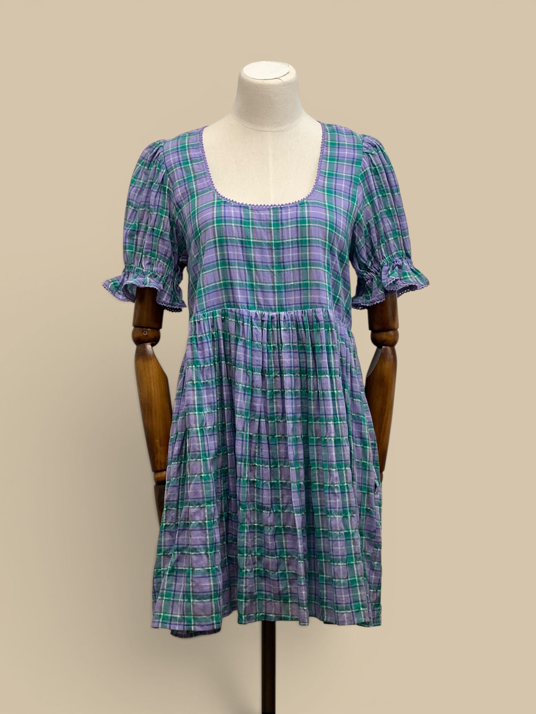 Homestyle Collective Dottie Babydoll Dress in lavender and teal plaid with ruffle trim and square neckline.