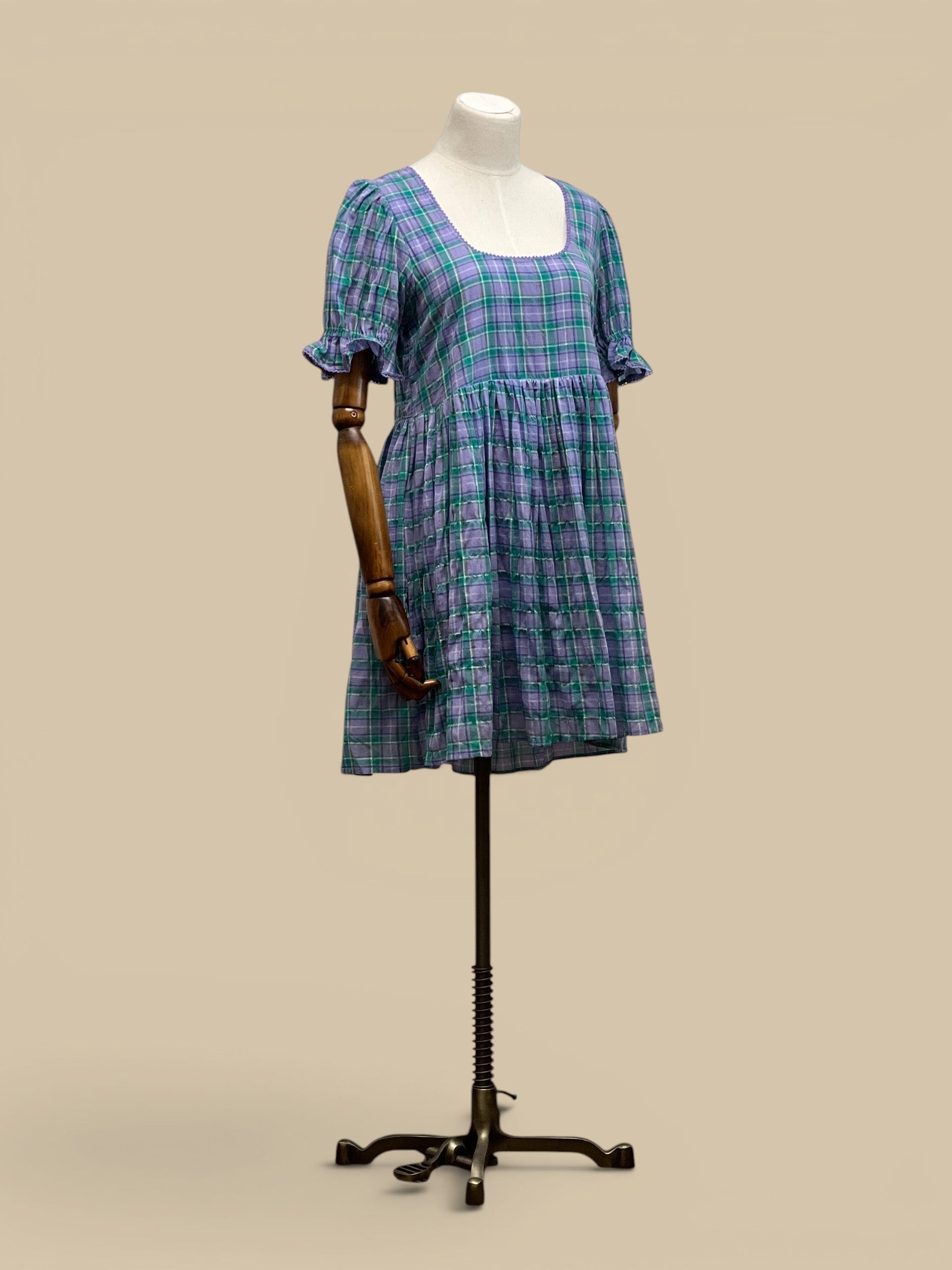 Homestyle Collective Dottie Babydoll Dress in lavender and teal plaid with ruffle trim and square neckline.