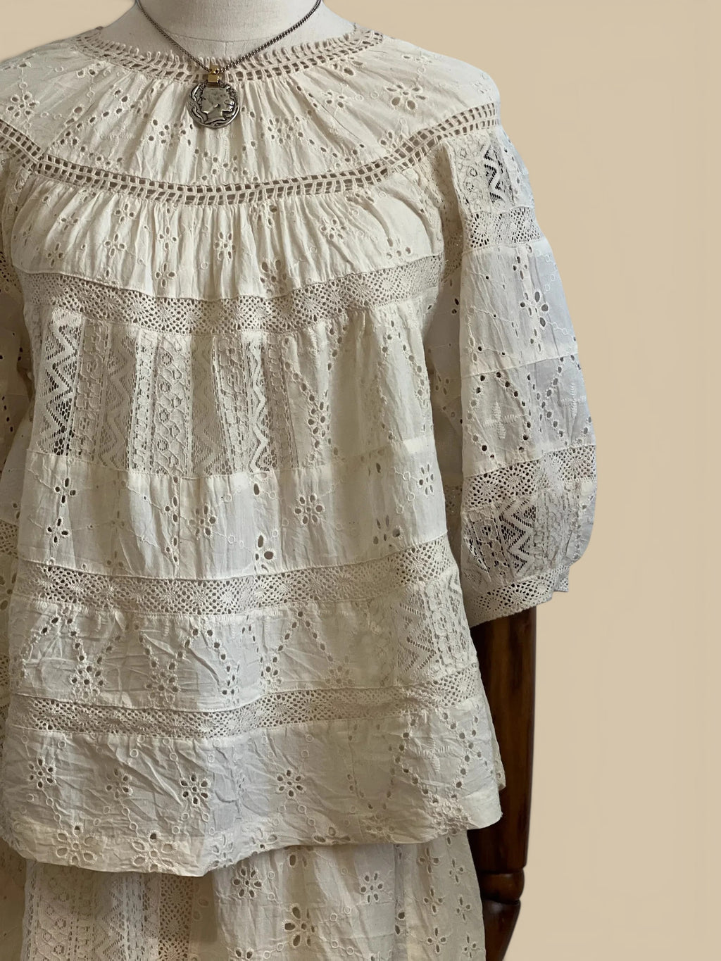 Homestyle Collective Dureya cream cotton eyelet top with intricate lace trim, crew neckline, and elbow-length sleeves.