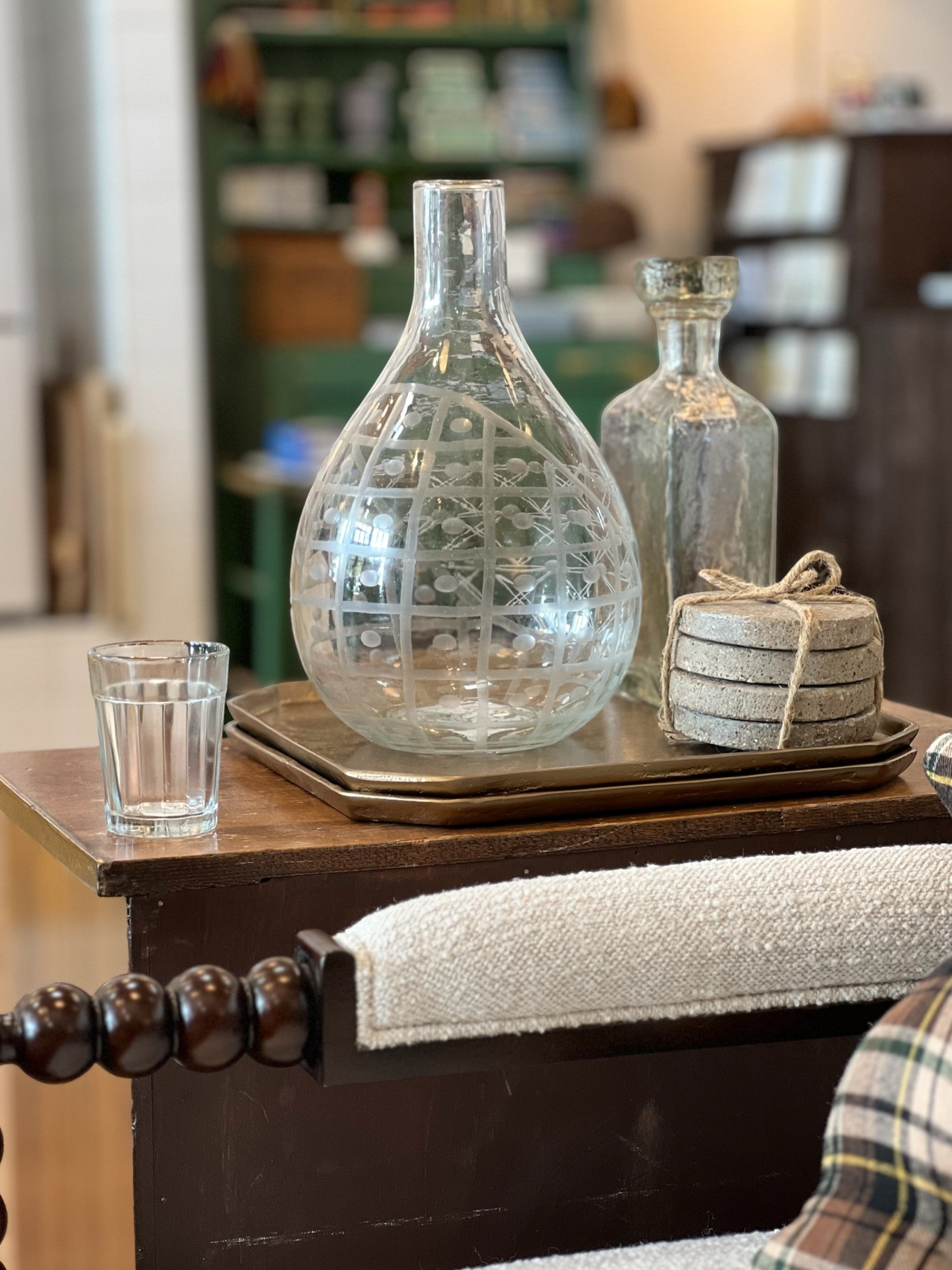 Homestyle Collective clear hand-blown glass pitcher with etched geometric and floral design. Versatile for serving or as a vase.