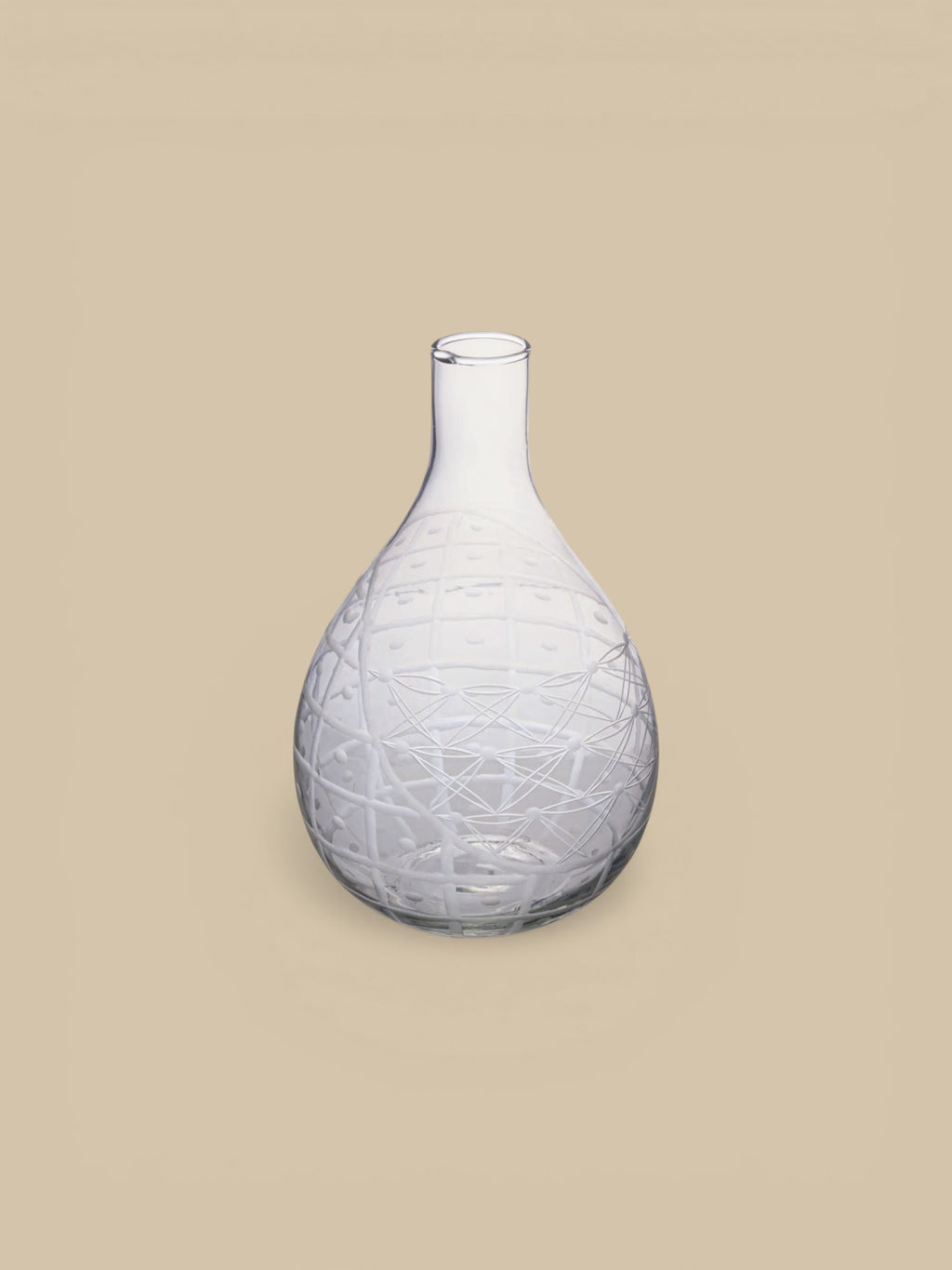 Homestyle Collective clear hand-blown glass pitcher with etched geometric and floral design. Handleless silhouette.