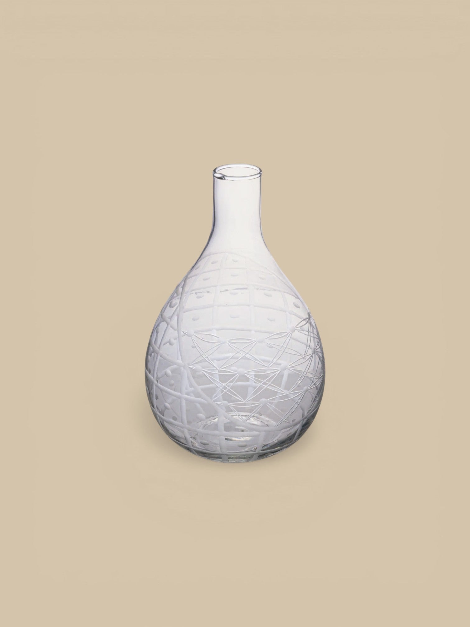 Homestyle Collective clear hand-blown glass pitcher with etched geometric and floral design. Handleless silhouette.