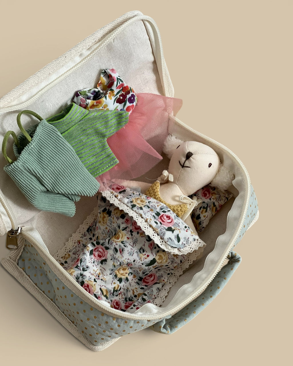 Homestyle Collective fabric suitcase playset featuring a stuffed bear with tiny outfits and floral bedding.