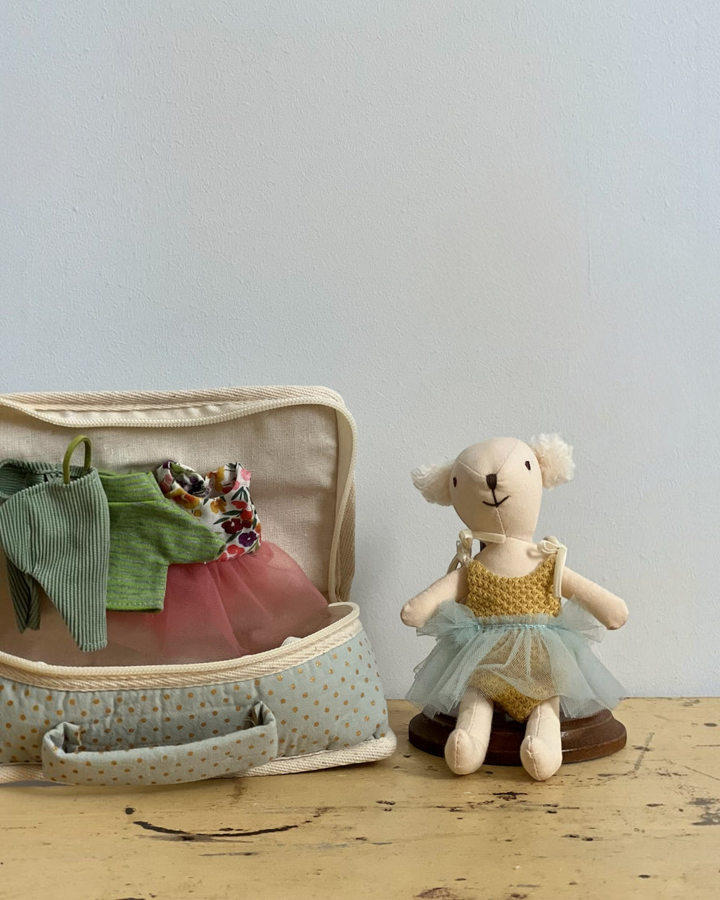 Homestyle Collective fabric suitcase playset featuring a stuffed bear doll with a tulle tutu and extra doll outfits.