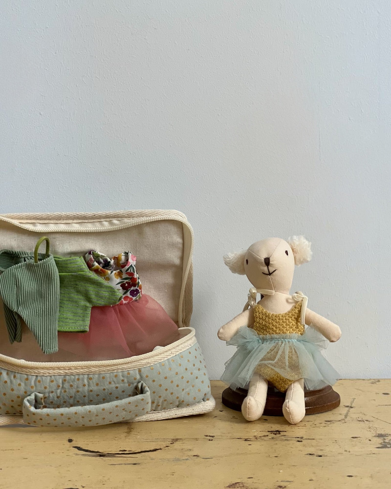 Homestyle Collective fabric suitcase playset featuring a stuffed bear doll with a tulle tutu and extra doll outfits.